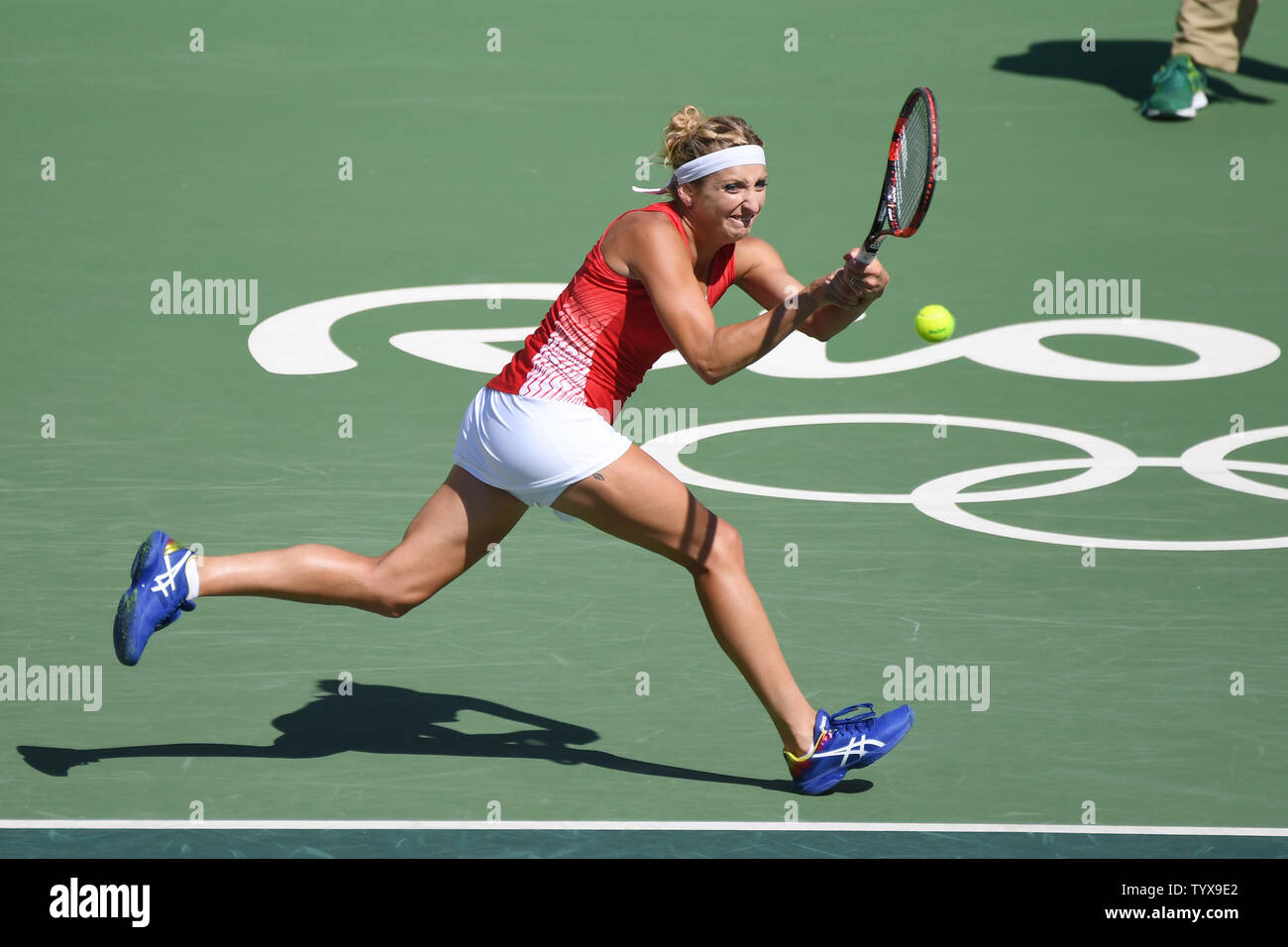 Timea Bacsinszky of Switzerland returns a volley during the gold medal match against Russia in women's doubles finals at the Olympic Tennis Stadium at the 2016 Rio Summer Olympics in Rio de Janeiro, Brazil, on August 14, 2016. Russia won the match and the gold medal and Switzerland the silver.        Photo by Richard Ellis/UPI. Stock Photo