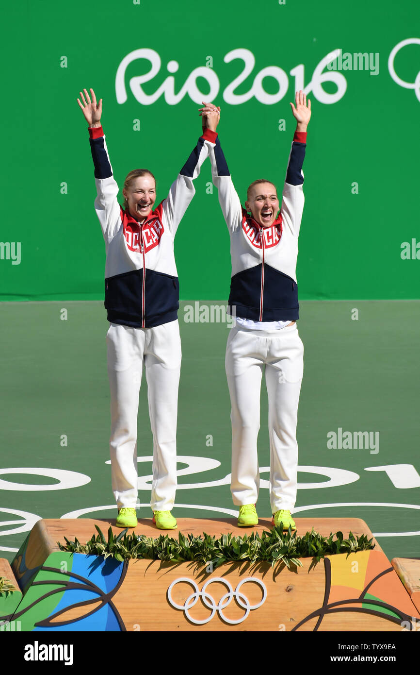 Ekaterina Makarova and Elena Vesnina of Russia raise their arms in victory during the award ceremony after defeating Switzerland to win the gold medal in women's doubles at the Olympic Tennis Stadium at the 2016 Rio Summer Olympics in Rio de Janeiro, Brazil, on August 14, 2016.         Photo by Richard Ellis/UPI.. Stock Photo