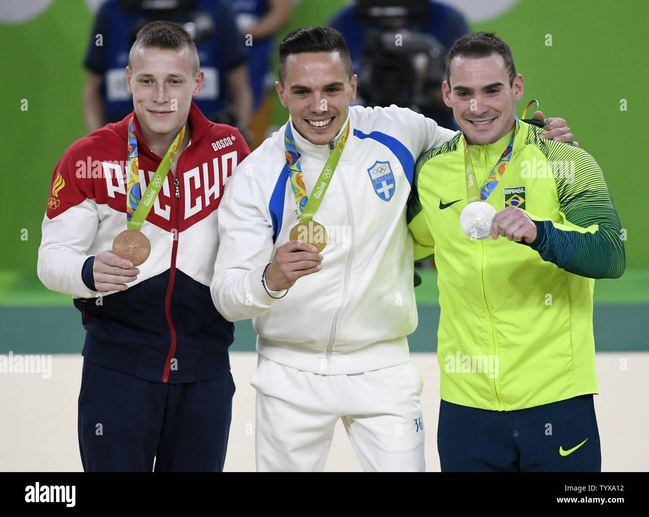 Greece's Eleftherios Petrounias (C) displays his Gold Medal along with Brazil's Arthur Zanetti (R) who won the Silver Medal and Russia's Denis Abliazin, who won the Bronze in the Men's Rings Final at the 2016 Rio Summer Olympics in Rio de Janeiro, Brazil, August 15, 2016.       Photo by Mike Theiler/UPI Stock Photo