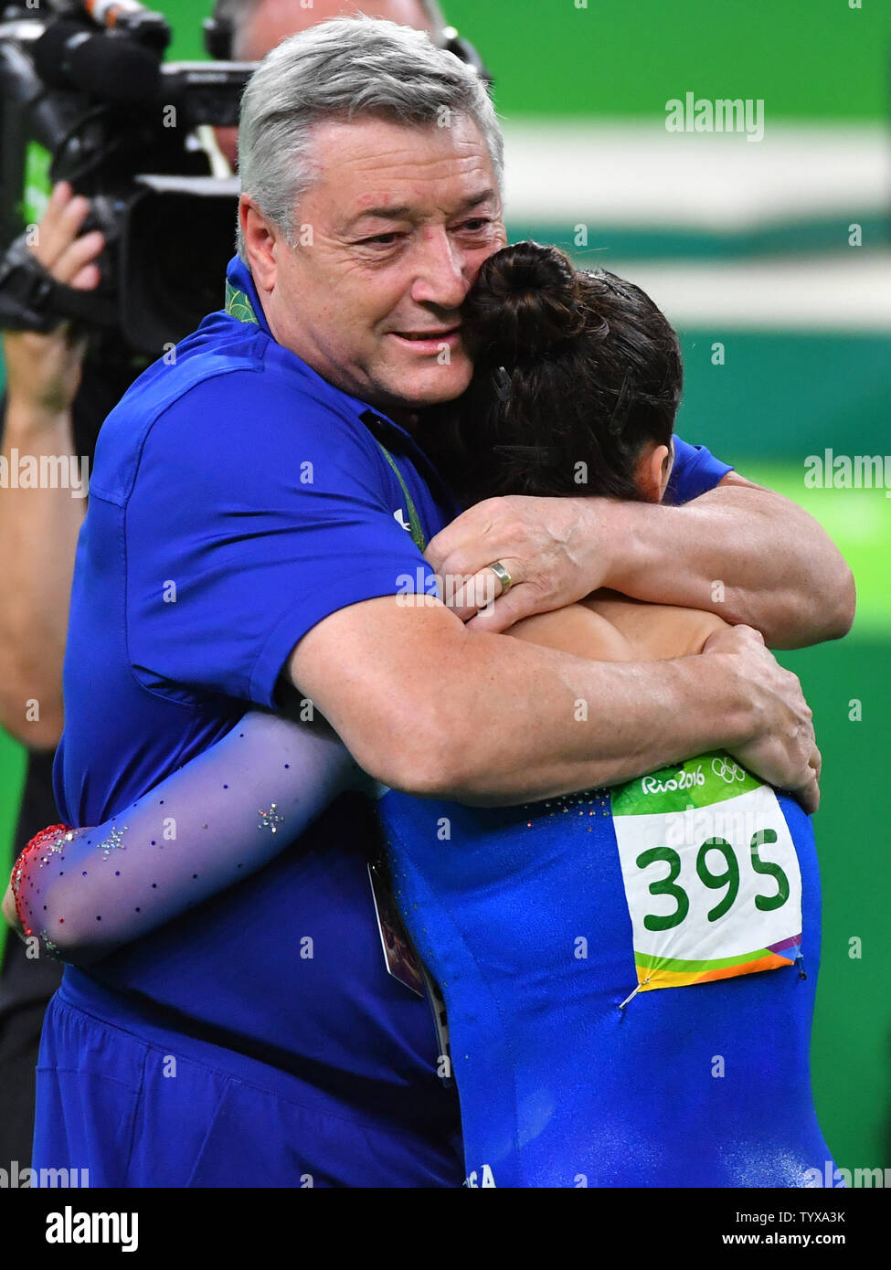 Aly Raisman and coach Mihai Brestyan of the United States embrace after ...