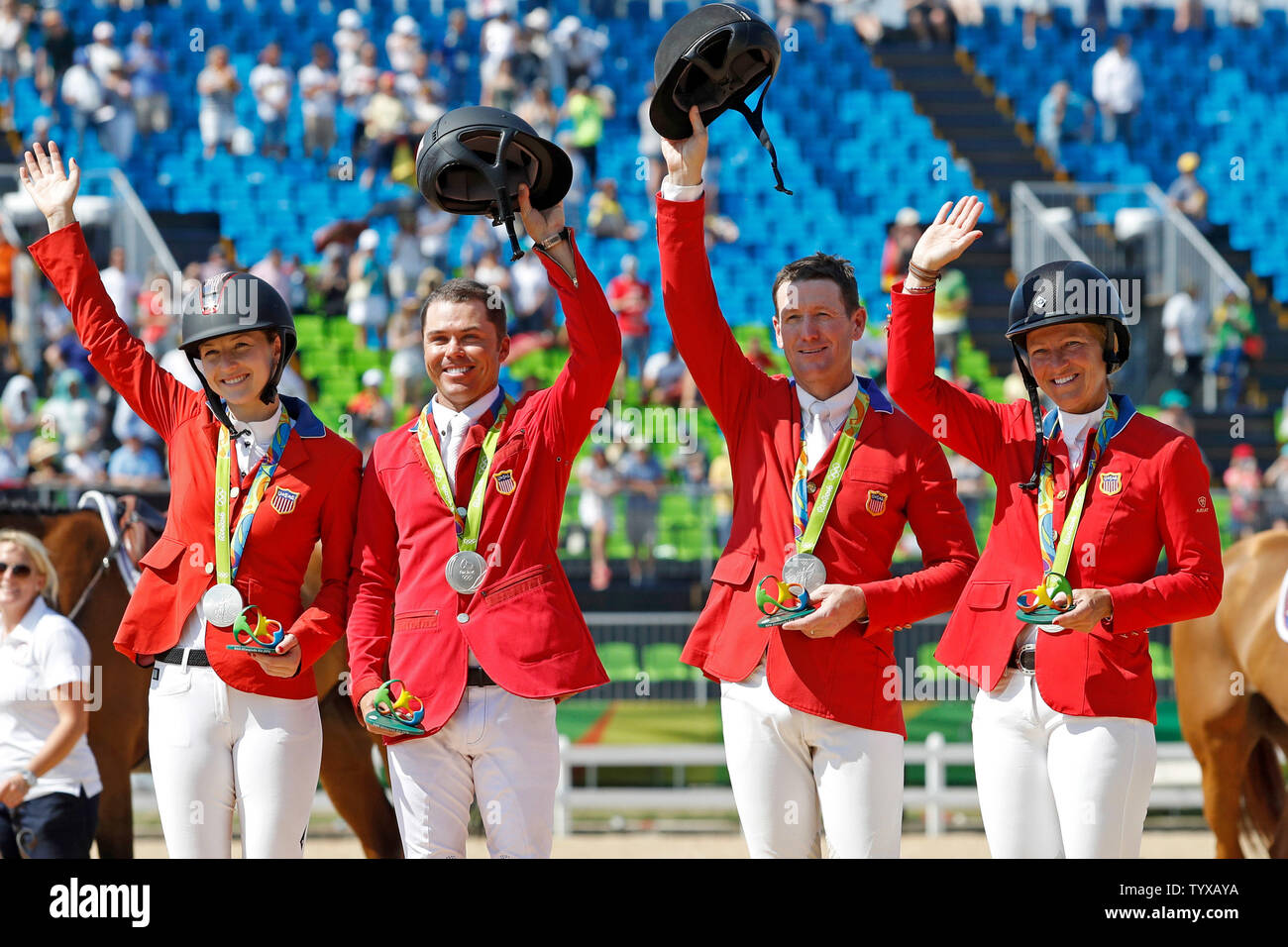 Team USA poses for a photo with their silver medals for the Equestrian Jumping Team finals in