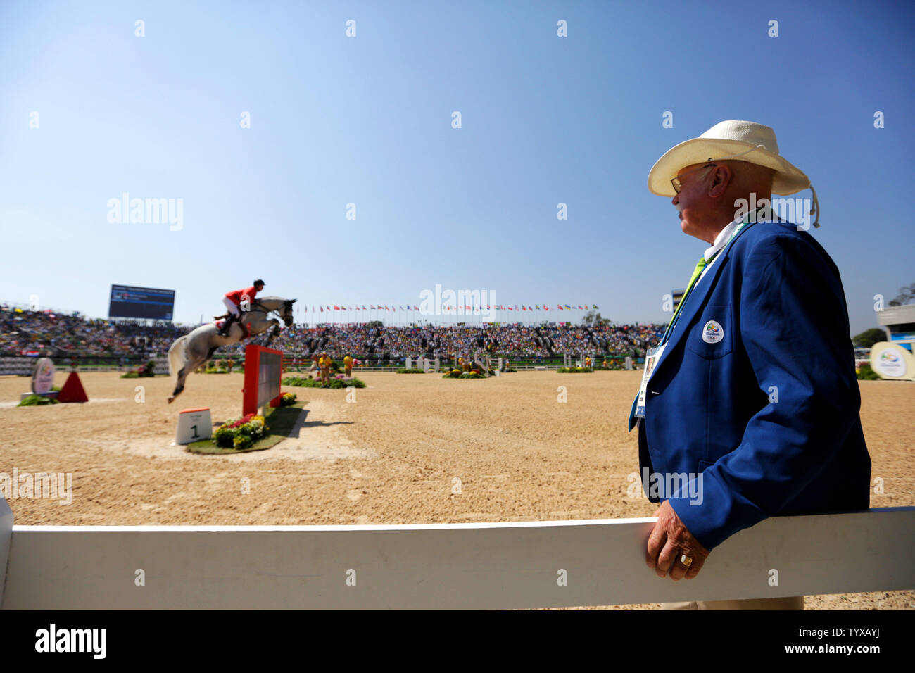 A judge watches Switzerland's Martin Fuchs clear the first jump during Equestrian Jumping Team finals and individual qualifiers in the Olympic Equestrian Centre at the 2016 Rio Summer Olympics in Rio de Janeiro, Brazil, on August 17, 2016.   Photo by Matthew Healey/UPI Stock Photo