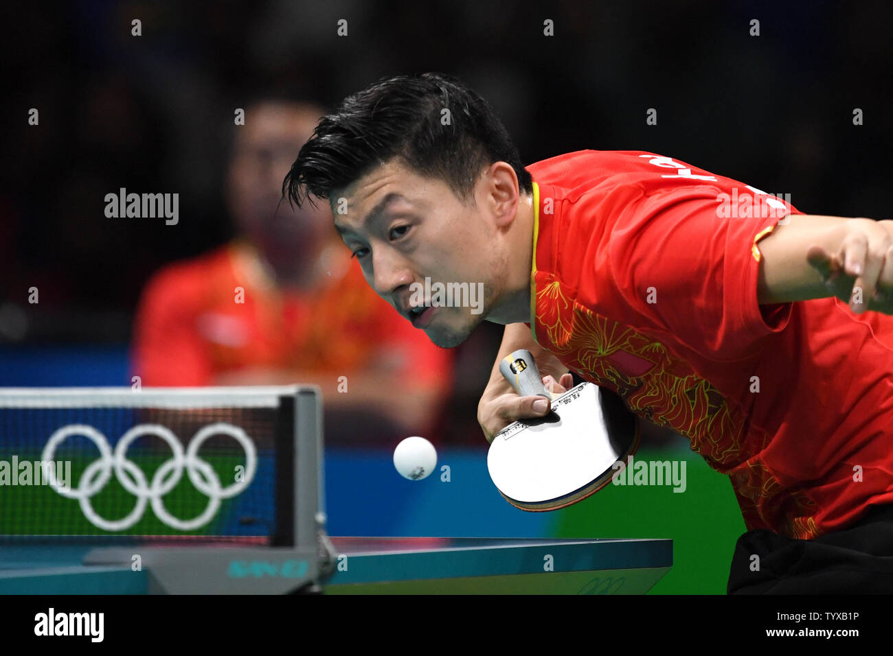 Ma Long of China in action against Koki Niwa of Japan in the Men's Team Table Tennis gold medal match in Riocentro Pavilion 3 at the 2016 Rio Summer Olympics in Rio de Janeiro, Brazil, on August 17, 2016.   Photo by Richard Ellis/UPI Stock Photo