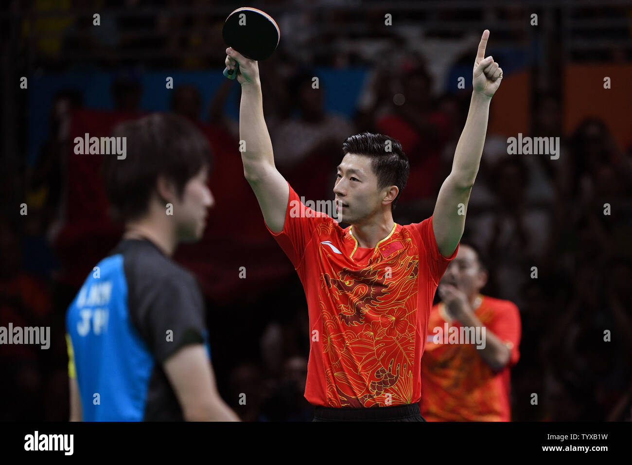 Ma Long of China celebrates his singles match against Koki Niwa of Japan in the Men's Team Table Tennis gold medal match in Riocentro Pavilion 3 at the 2016 Rio Summer Olympics in Rio de Janeiro, Brazil, on August 17, 2016.   Photo by Richard Ellis/UPI Stock Photo