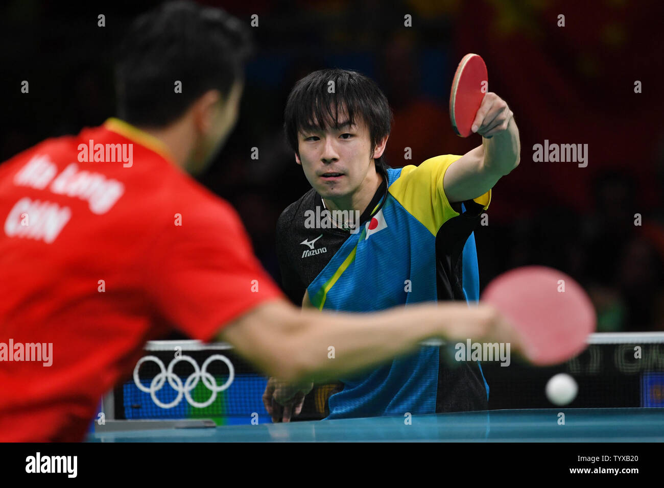 Koki Niwa of Japan in action against Ma Long of China in the Men's Team Table Tennis gold medal match in Riocentro Pavilion 3 at the 2016 Rio Summer Olympics in Rio de Janeiro, Brazil, on August 17, 2016.   Photo by Richard Ellis/UPI Stock Photo