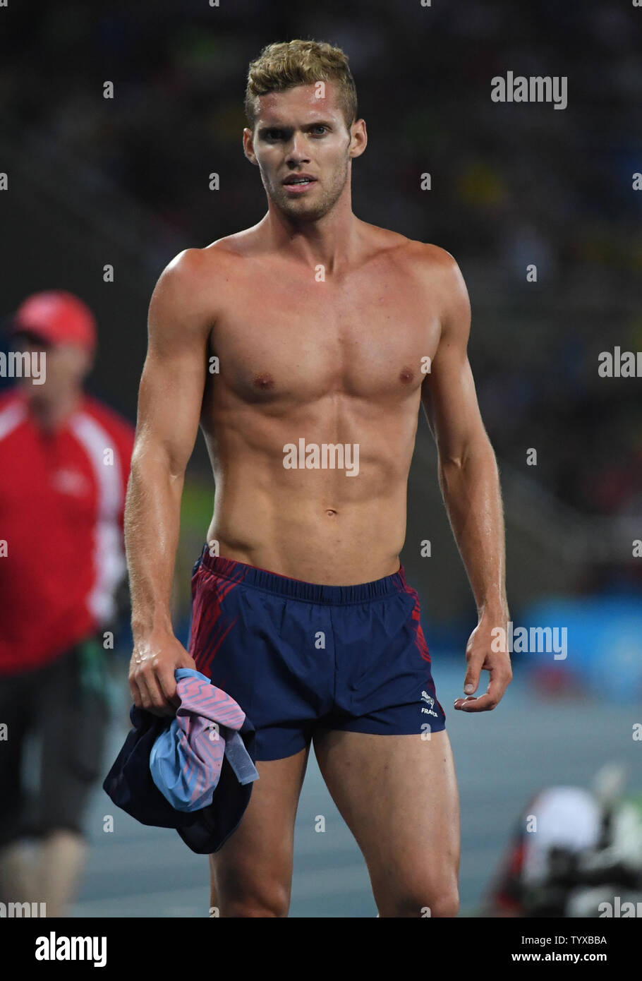 Silver medalist Kevin Mayer of France takes his shirt off after the Men's  Decathlon 1500m at the Olympic Stadium at the 2016 Rio Summer Olympics in  Rio de Janeiro, Brazil, on August