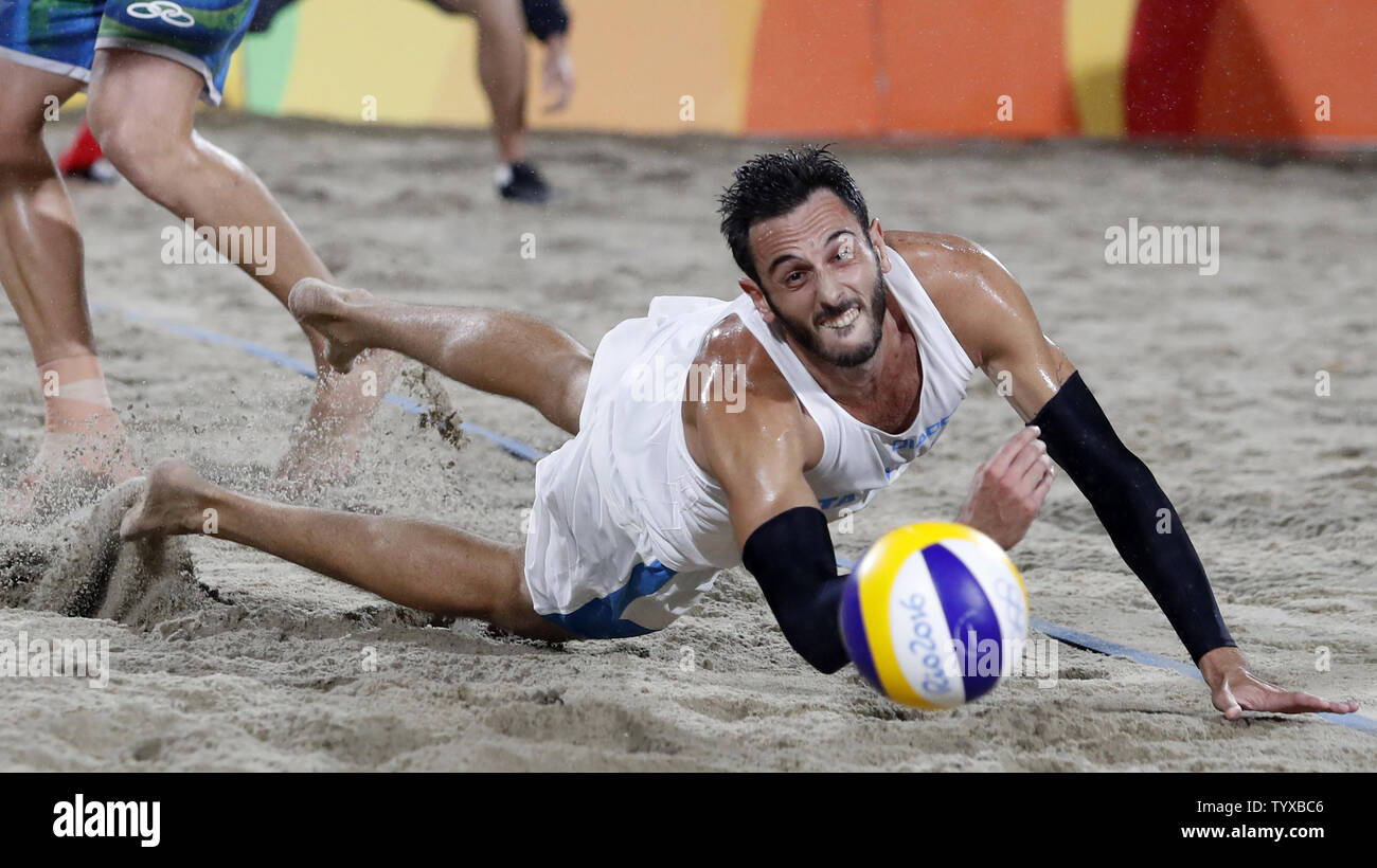 Paolo Nicolai of Italy dives to the sand for a ball in the Men's Beach