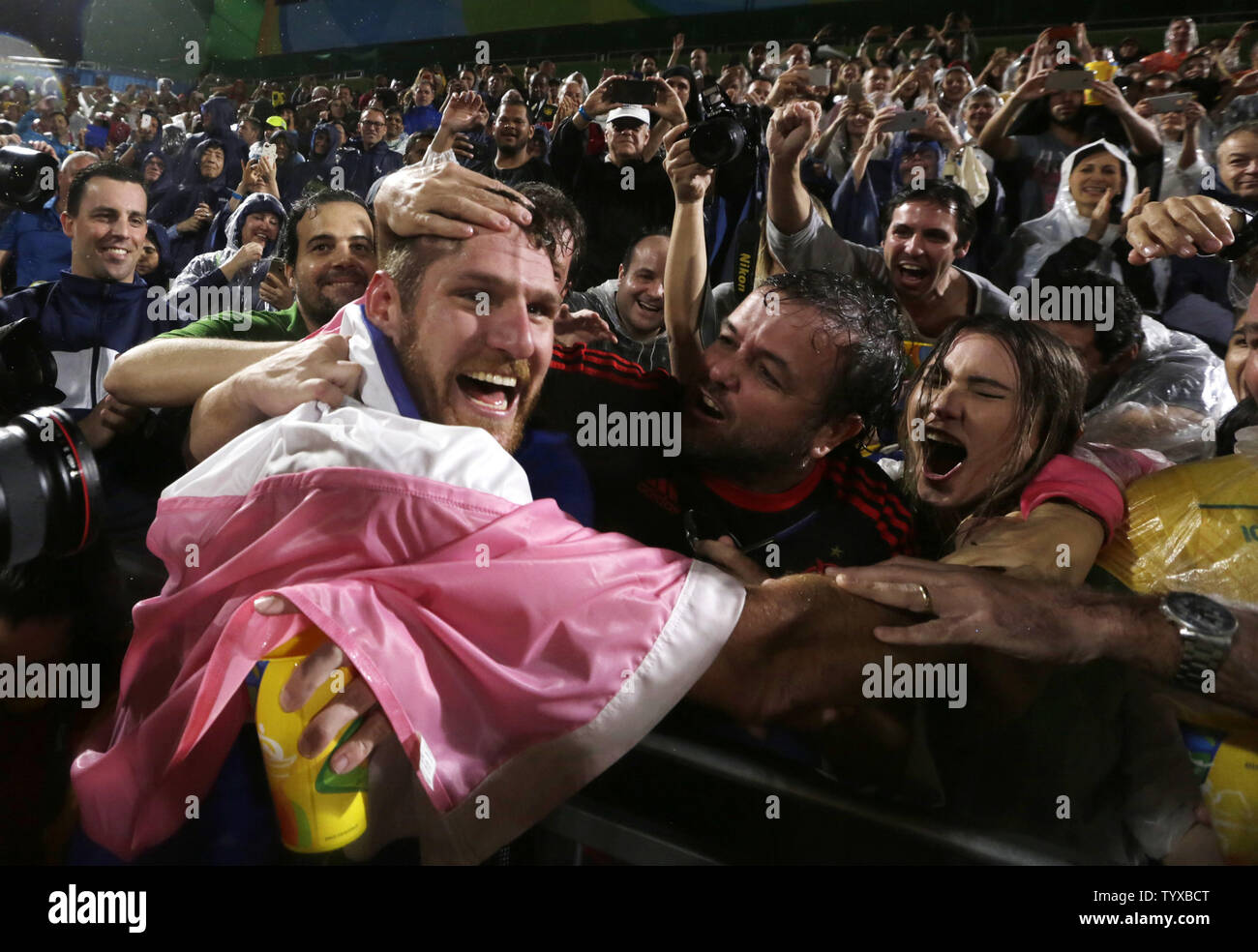 Alison Cerutti of Brazil celebrates with fans after winning the Men's