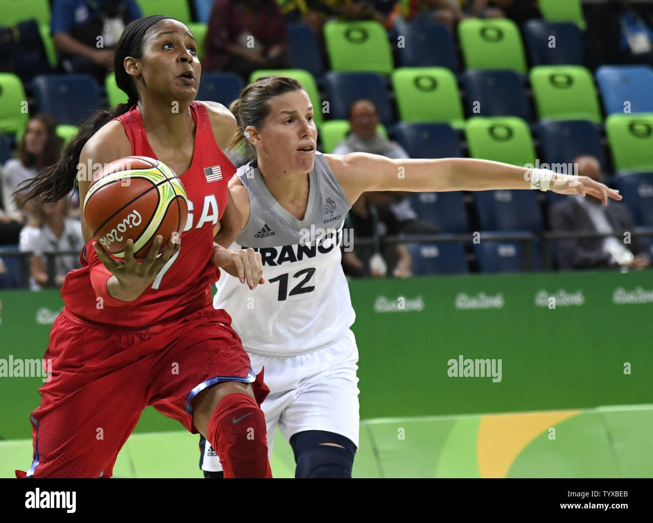United States' Maya Moore dribbles to the basket against France's Gaelle  Skrela during the USA vs France Women's Basketball game at the 2016 Rio  Summer Olympics in Rio de Janeiro, Brazil, August