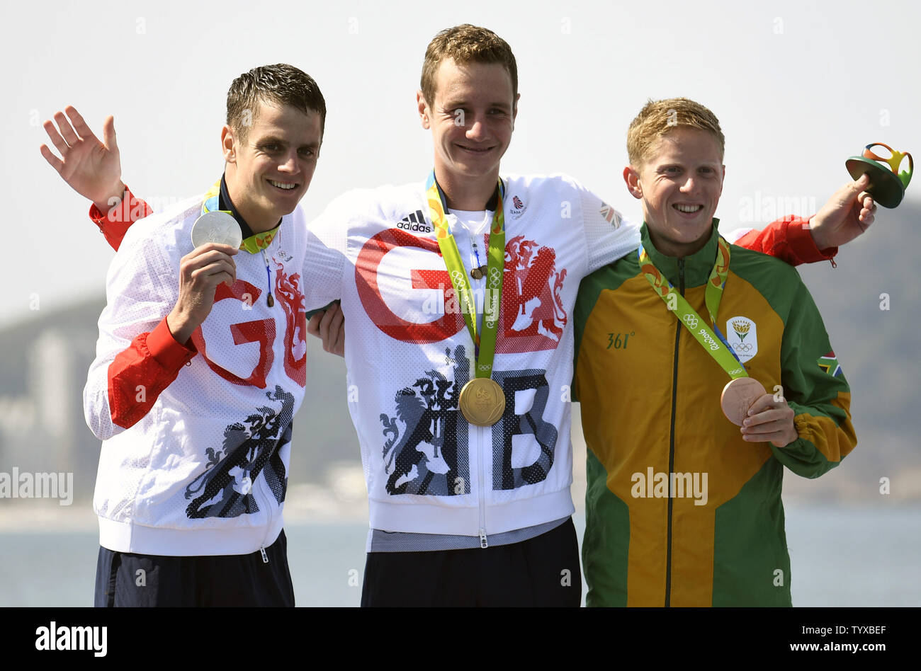 Great Britain S Alistair Brownlee C Winner Of The Gold Medal And His Brother Jonathan L Who Won The Silver Celebrate With South Africa S Henri Schoeman During The Medal Ceremony For The Men S