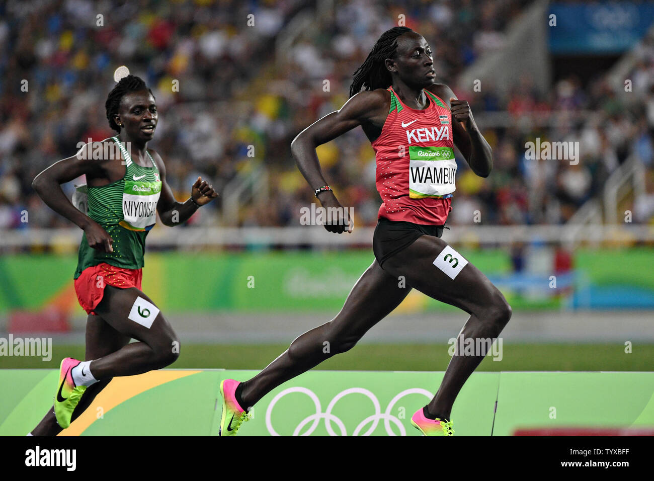 Margaret Nyairera Wambui of Kenya moves to pass Francine Niyonsaba of