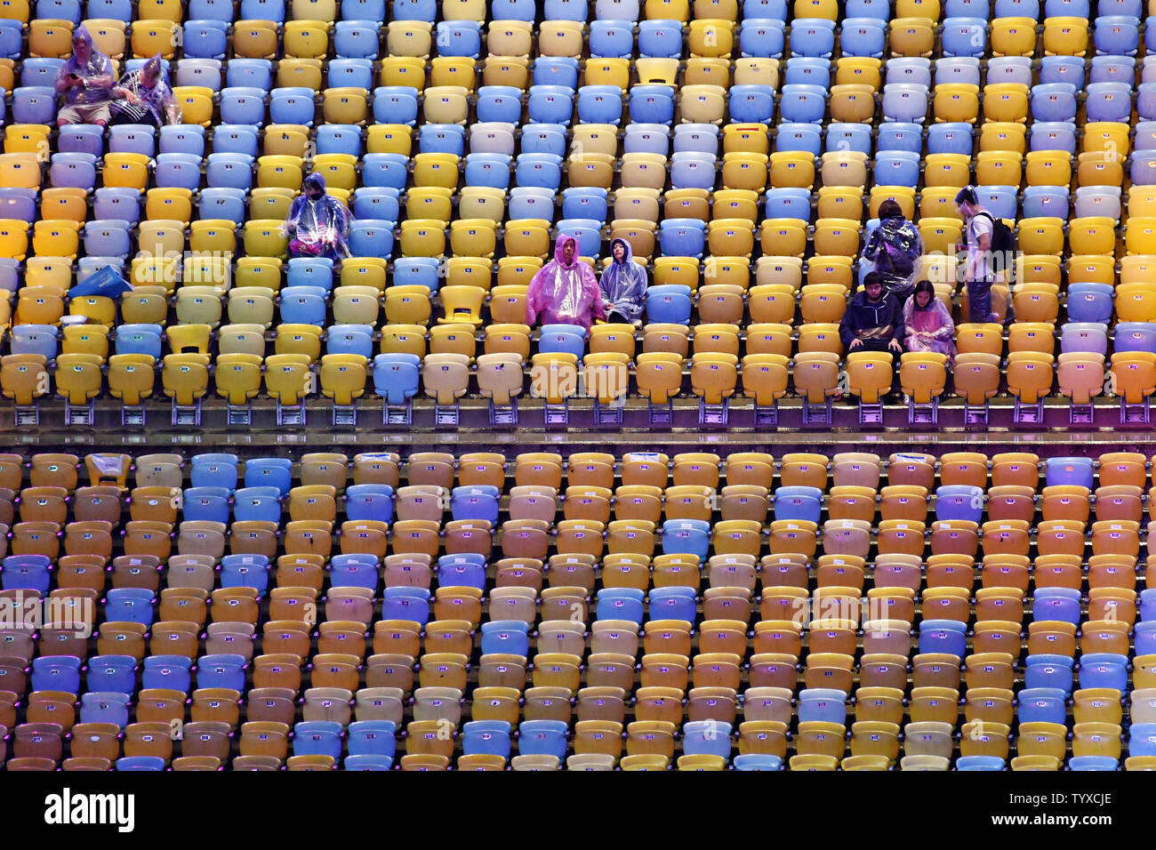 A few hardy spectators brave the rain as they wait for the start of the Closing Ceremony bringing to a close the 2016 Rio Summer Olympics at Maracan‹ Stadium in Rio de Janeiro, Brazil, on August 21, 2016.      Photo by Richard Ellis/UPI Stock Photo