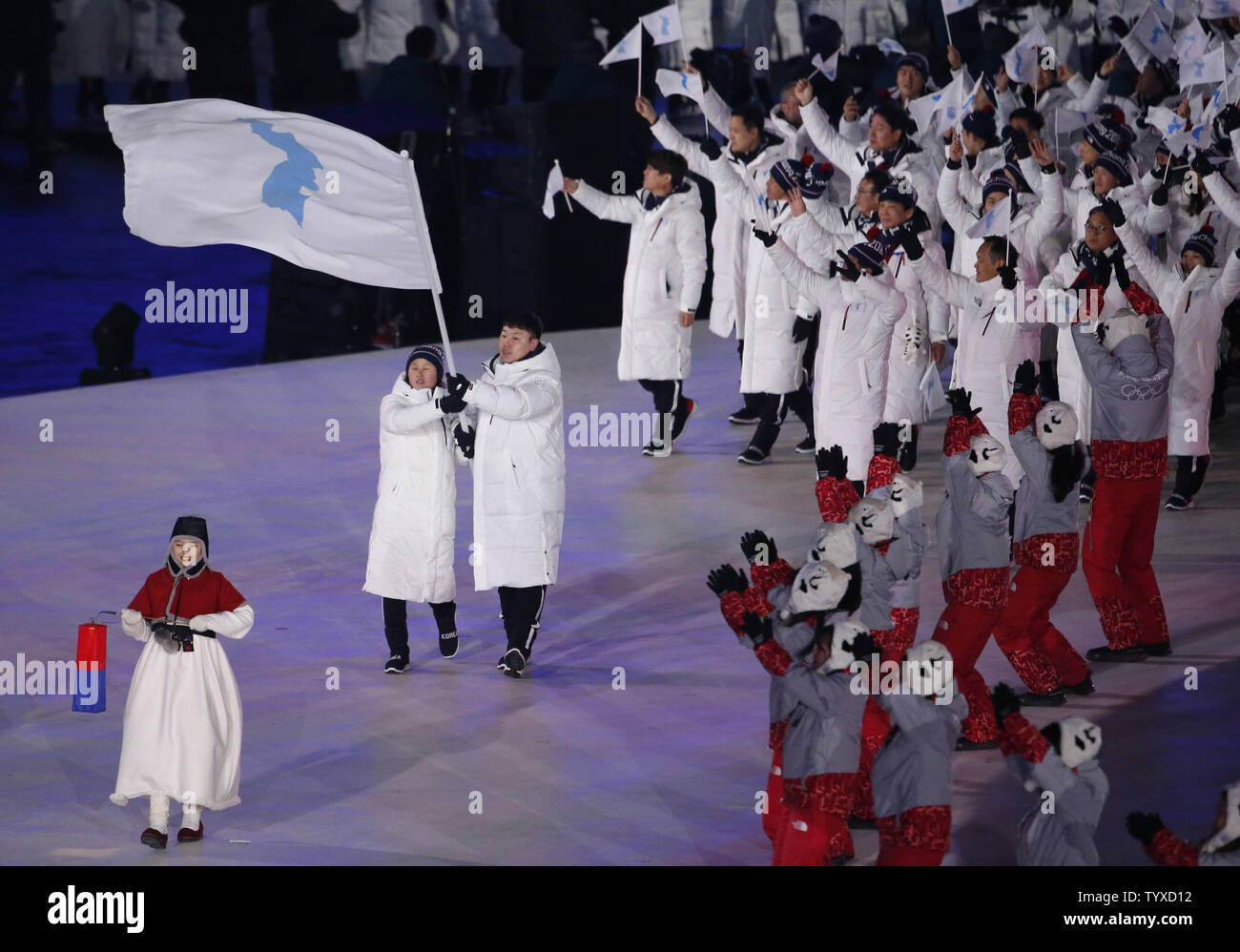 North and South Korean athletes walk together under one flag during the