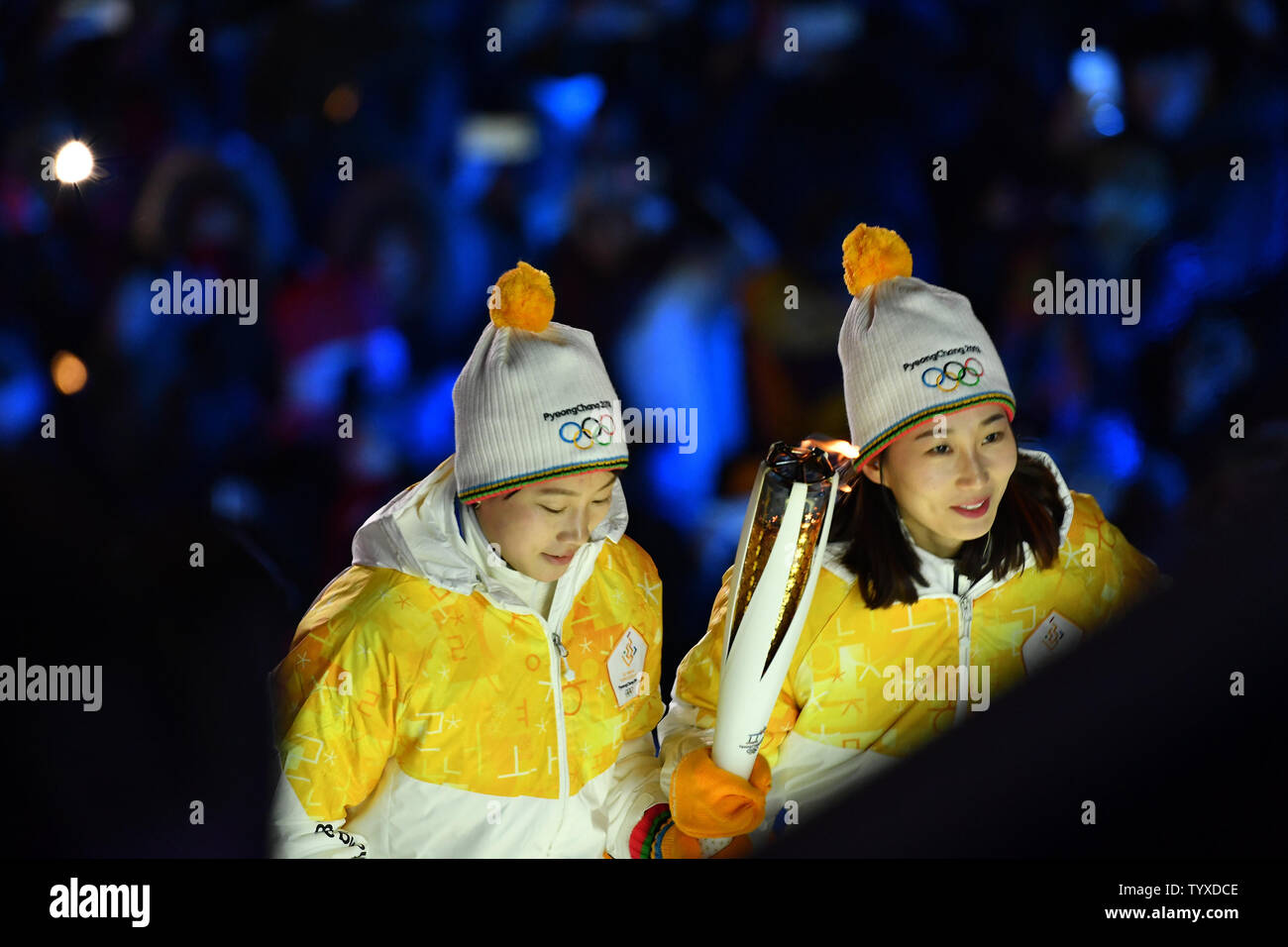 The Olympic torch is carried up the ramp to light the cauldron by two members of the mixed North and South Korean women's hockey team, Chung Su-hyon of North Korea and Park Jong-ah of South Korea during the opening ceremony at the Pyeongchang 2018 Winter Olympics, at the Olympic Stadium in Daegwalnyeong, South Korea, on February 9, 2018. photo by Richard Ellis/UPI Stock Photo