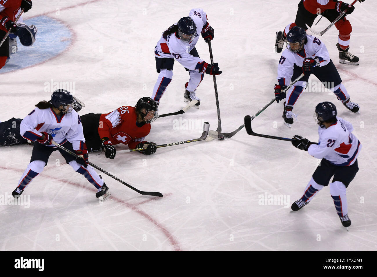 Dominique Ruegg (#26) of Switzerland is checked by Park Yoon-jung (#23), Han Soo-jin (#17) and Jong Su-hyon (#27) of the joint North and South Korean team during the Women's Ice Hockey Preliminary Round - Group B game at the Kwandong Hockey Center in Gangneung, South Korea during the 2018 Pyeongchang Winter Olympics on February 10, 2018. The joint North and South Korean ice hockey team competed together as 'Korea' under the unified flag at the Winter Olympics. Switzerland won 8-0.  Photo by Andrew Wong/UPI Stock Photo