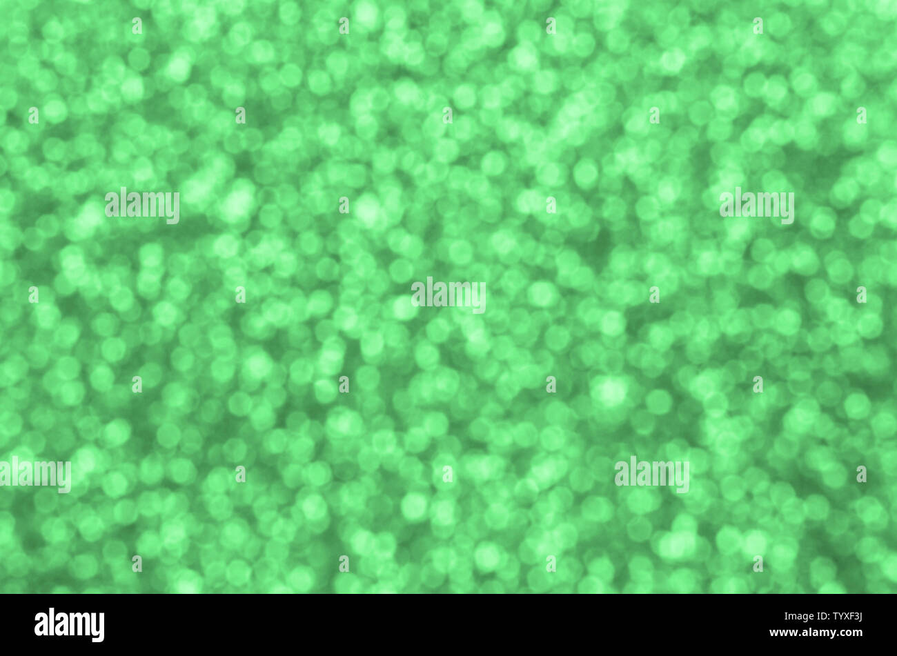 Blurred green decorative sequins. Background image with shiny bokeh ...