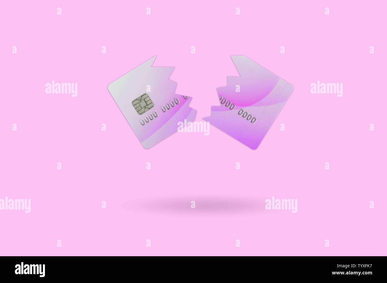 Cut and broken purple credit card floating in the pastel pink space. The concept of ban to use banking services. Credit card expire end soon Stock Photo
