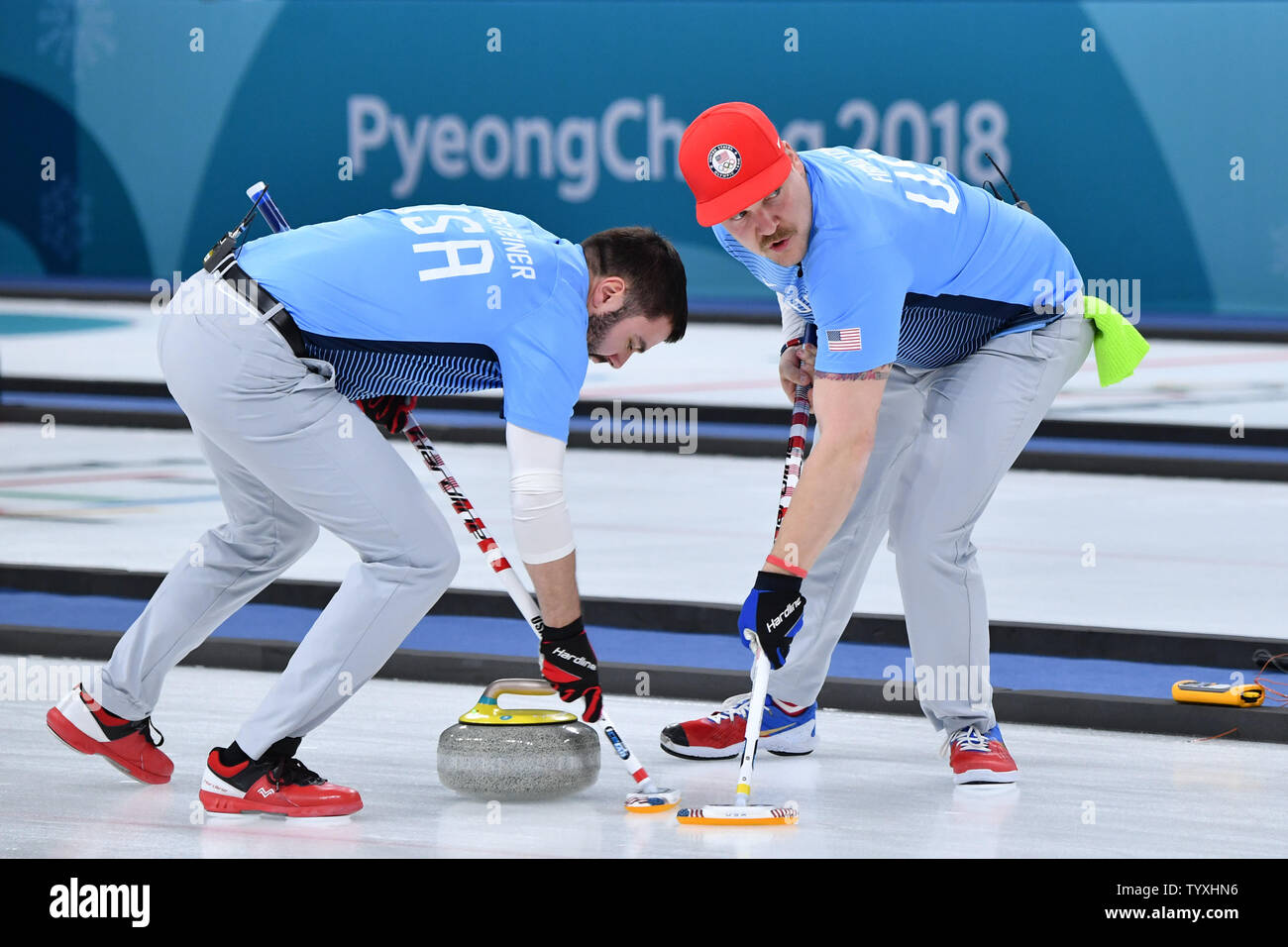 Matt Hamilton, right, and John Landsteiner of the United States sweep ahead of the stone during the Men's Curling finals at the Pyeongchang 2018 Winter Olympics, in the Gangneung Curling Centre in Gangneung, South Korea, on February 24, 2018. The USA won the gold medal for the first time beating Sweden who took the silver and Switzerland the bronze. Photo by Richard Ellis/UPI Stock Photo