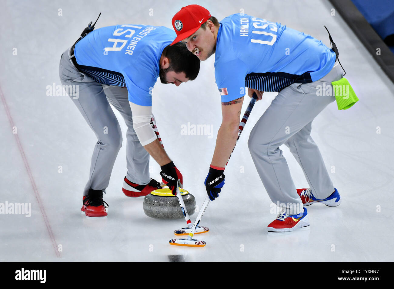 Matt Hamilton, right, and John Landsteiner of the United States sweep ahead of the stone during the Men's Curling finals at the Pyeongchang 2018 Winter Olympics, in the Gangneung Curling Centre in Gangneung, South Korea, on February 24, 2018. The USA won the gold medal for the first time beating Sweden who took the silver and Switzerland the bronze. Photo by Richard Ellis/UPI Stock Photo