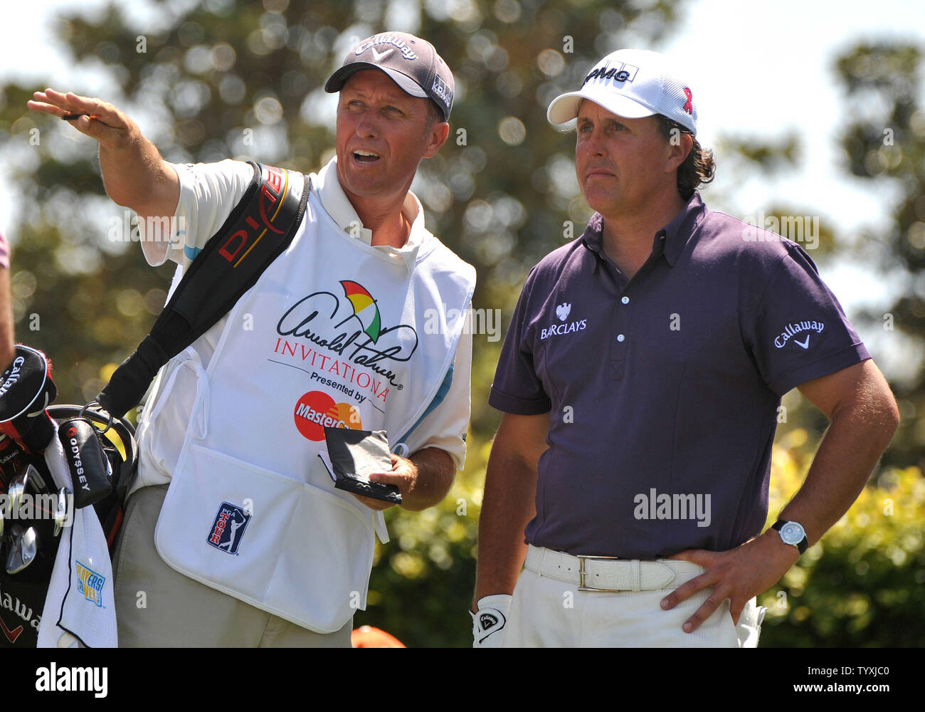 Phil Mickelson and his caddy caddie Jim Mackay line up a drive on the