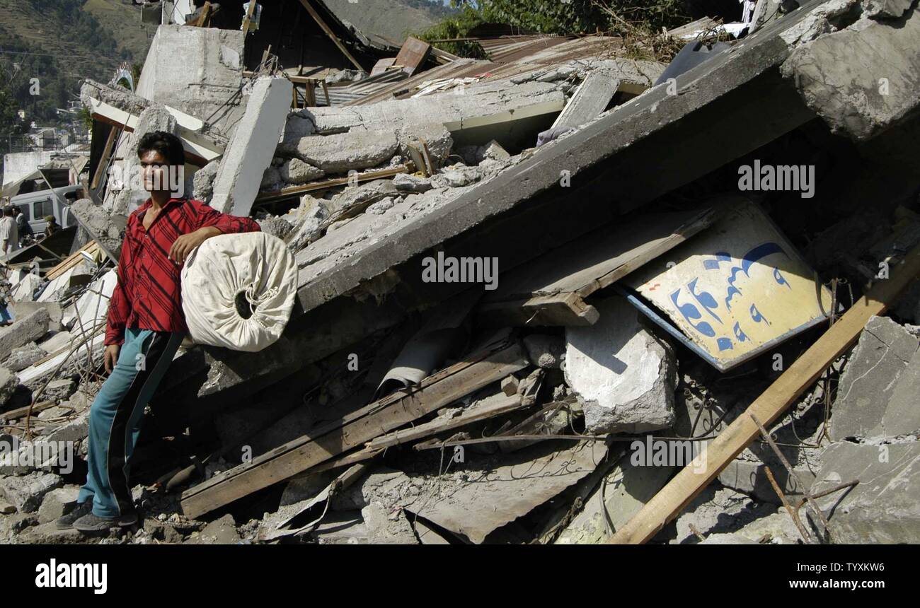 One of the earthquake victim sits on a wall in front of his collapsed house in Muzaffarabad, Pakistan on October 14, 2005.  More than 2 million people are homeless and officials estimate that more than 35,000 died during the earthquake. (UPI Photo/Ahmad Abbasi) Stock Photo