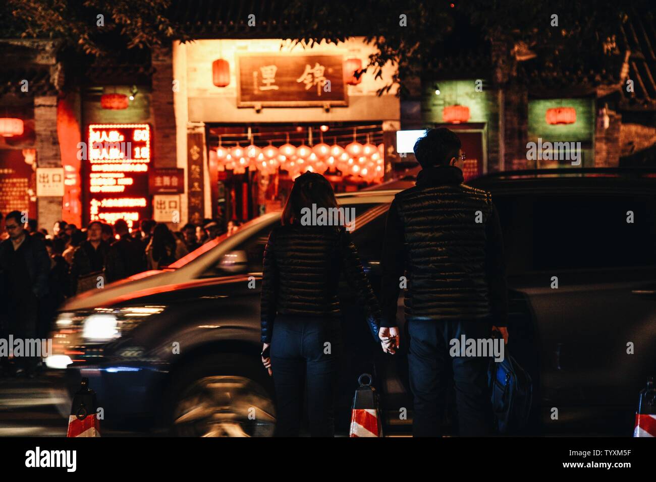 A couple is crossing the street on Jinli Ancient Street in Chengdu at the Tanabata Festival. Stock Photo