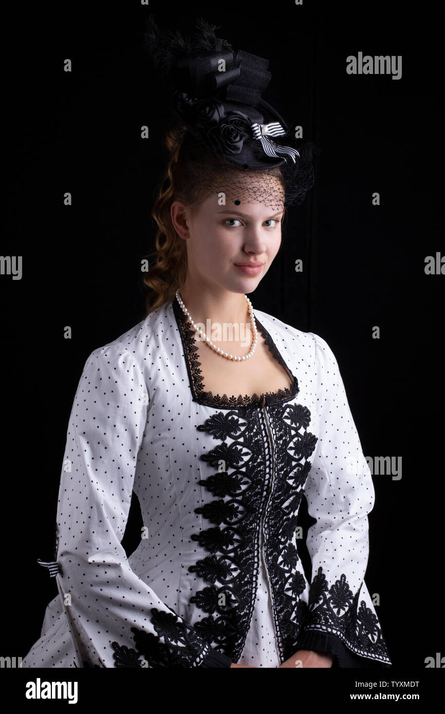 Victorian woman in black and white bustle dress Stock Photo