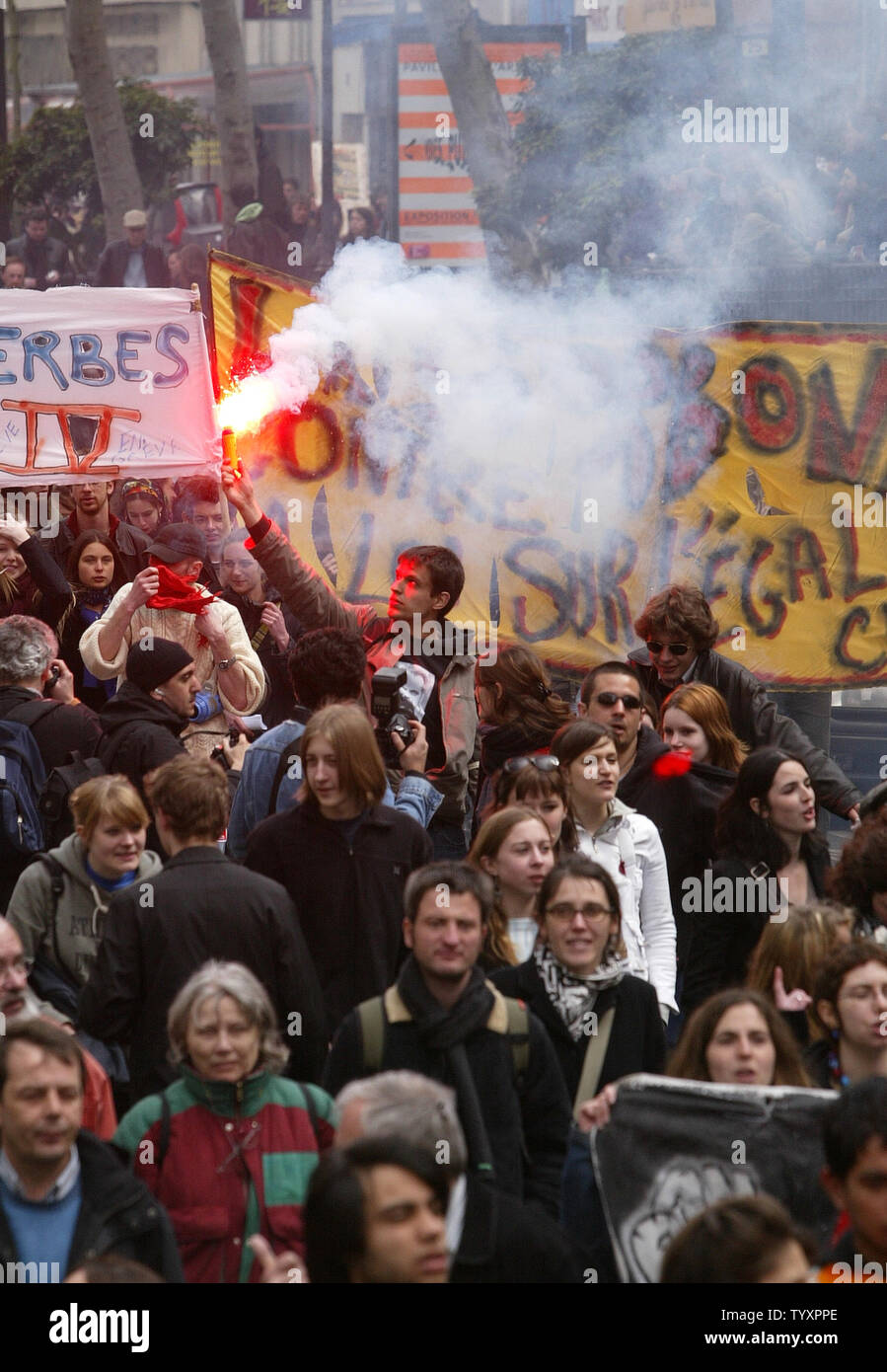 A French student holds a flare during a protest march along one of Paris' main avenues April 11, 2006. Hundreds of students, emboldened by President Jacques Chirac's cave-in on the First Employment Contract (CPE), went ahead with a pre-planned demonstration in a bid to get rid of other government labor reforms.  (UPI Photo/Eco Clement) Stock Photo