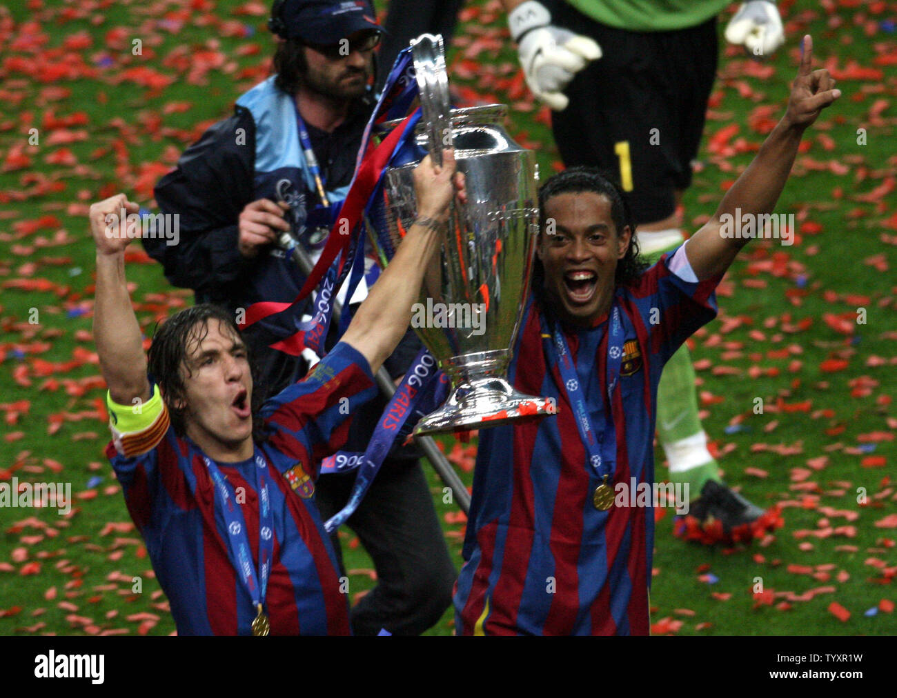 FC Barcelona captain Carlos Puyol (L) and Ronaldino hold the trophy at the  end of their UEFA Champions League soccer final against Arsenal FC at the  Stade de France in Saint Denis,