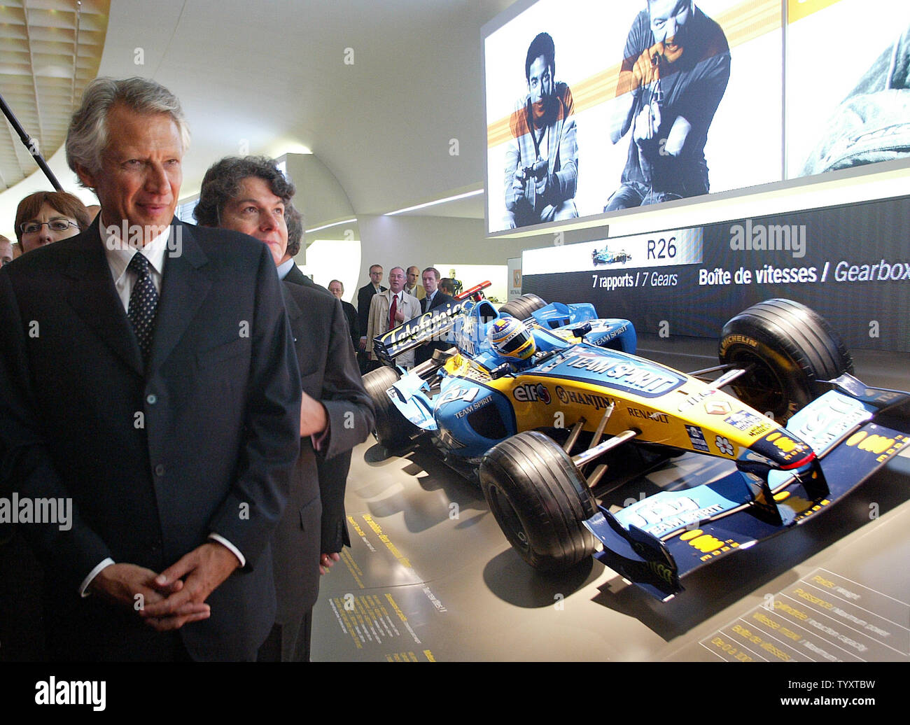 French Prime Minister Dominique de Villepin walks past the Renault F1 Team R26 sports car as he tours the Paris International Auto Show, Friday, September 29, 2006. The show is to open its doors to the public September 30. (UPI Photo/Eco Clement) Stock Photo