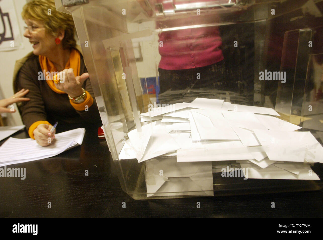 A worker of the French Socialist Party points to a box filed with ballots during the party's primary for the next French presidential election in Paris, November 16, 2006. Three candidates, Segolene Royal, Dominique Strauss-Khan and Laurent Fabius, are vying to lead the Socialist Party into next year's French presidential election.(UPI Photo/Eco Clement) Stock Photo