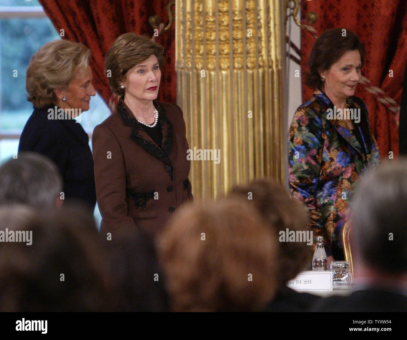 Suzanne Mubarak (R), wife of the Egyptian president and Bernadette Chirac (L), wife of the French president  walk past U.S. First Lady Laura Bush at the start of a conference at the Elysee Palace in Paris, January 17, 2007. The First Ladies met to form a committee for the defense of lost or exploited children. (UPI Photo/Eco Clement) Stock Photo