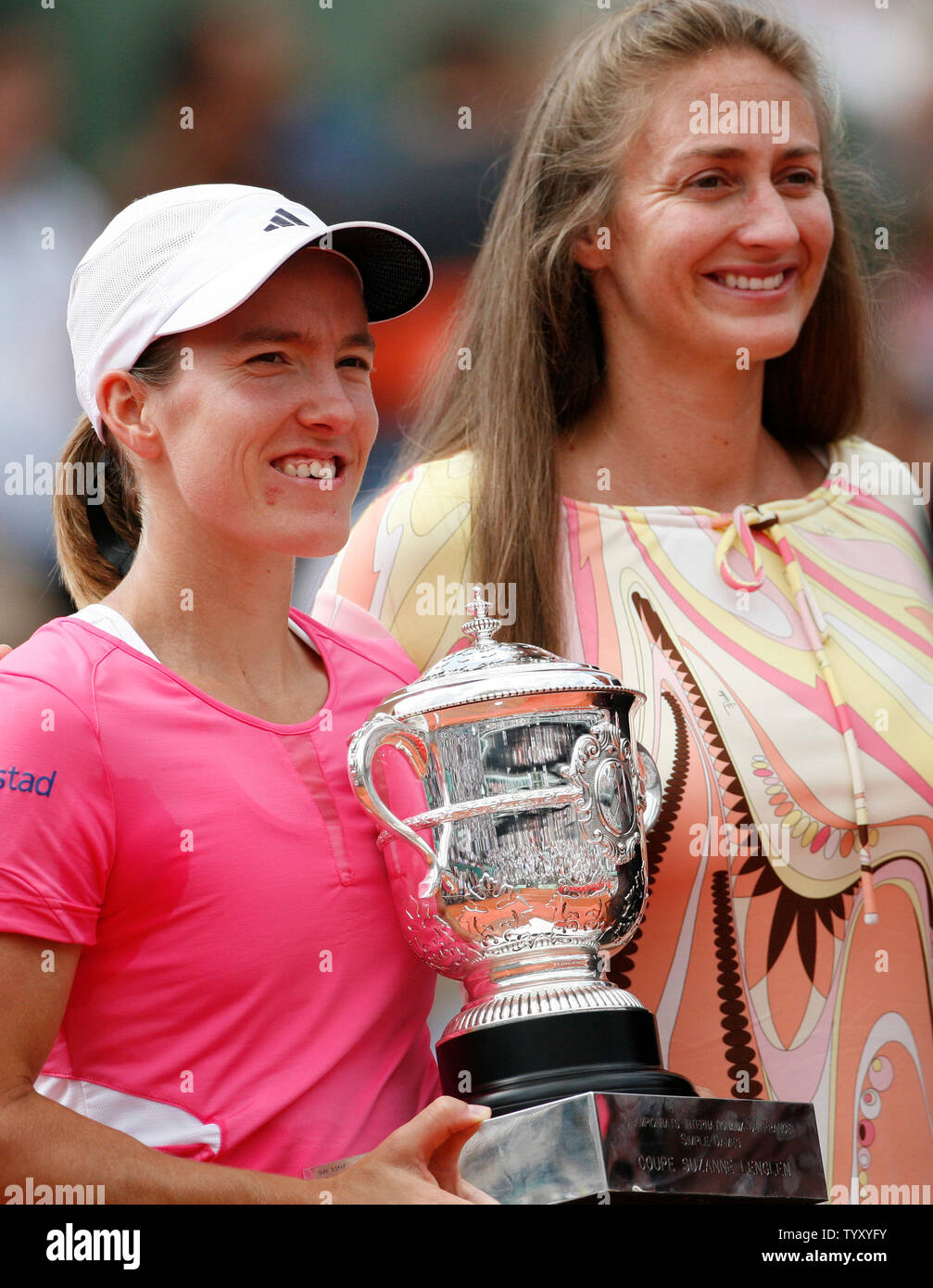 Belgian Justine Henin (L) holds the championship trophy while posing with former French Open champion Mary Pierce after Henin won her final round match against Serbian Ana Ivanovic at the French Open at Roland Garros in Paris on June 9, 2007.   Henin, the top seed, defeated the seventh-seeded Ivanovic in straight sets 6-1, 6-2 to win her third straight French Open Championship.   (UPI Photo/ David Silpa) Stock Photo