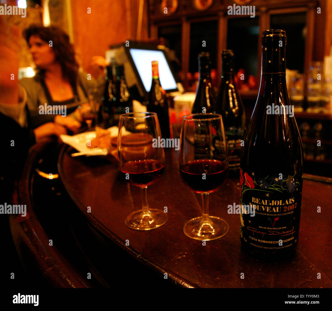 Bottles of justreleased Beaujolais Nouveau wine rest on the bar during