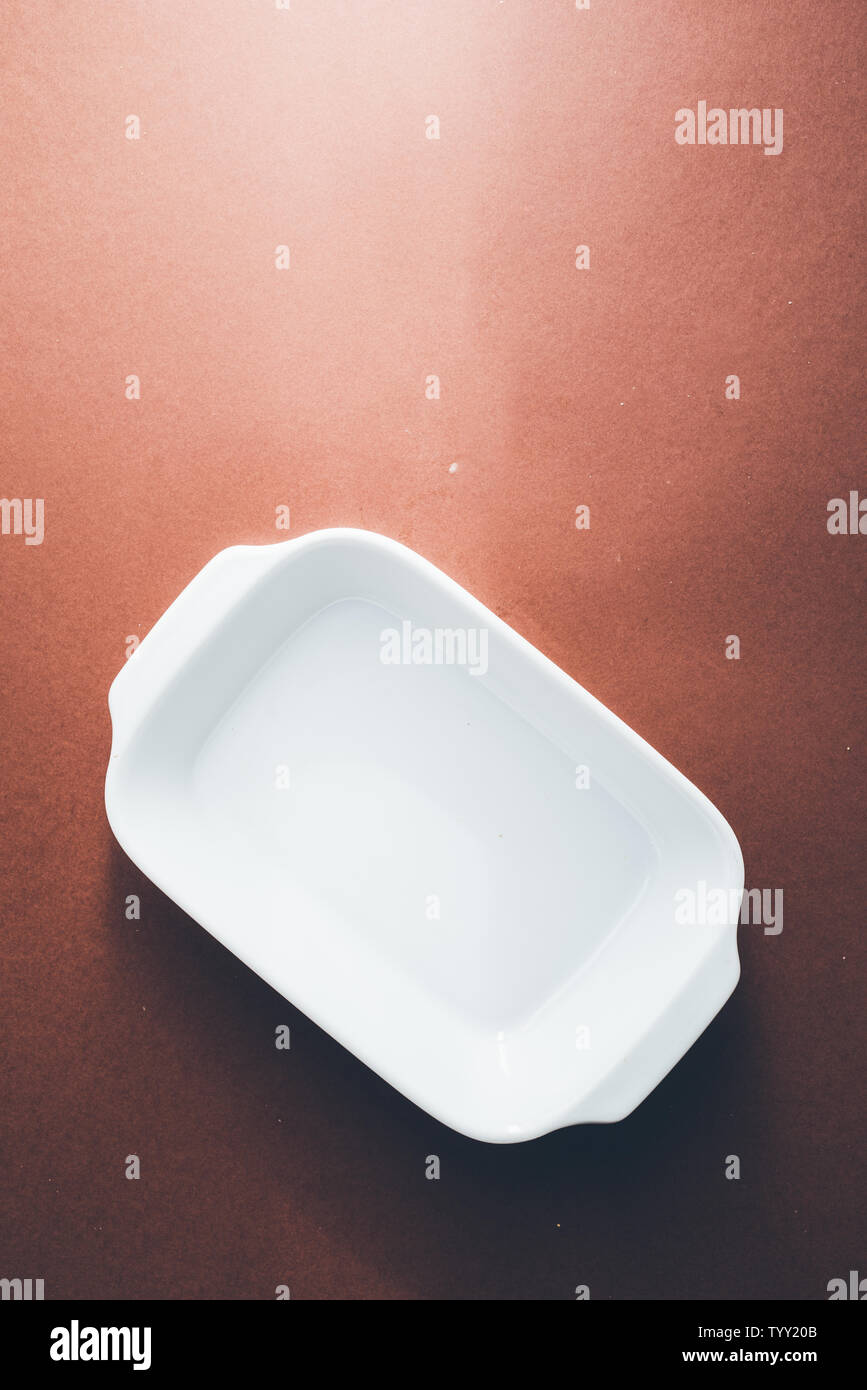 Empty rectangular White baking dish over a brown background, top view Stock Photo