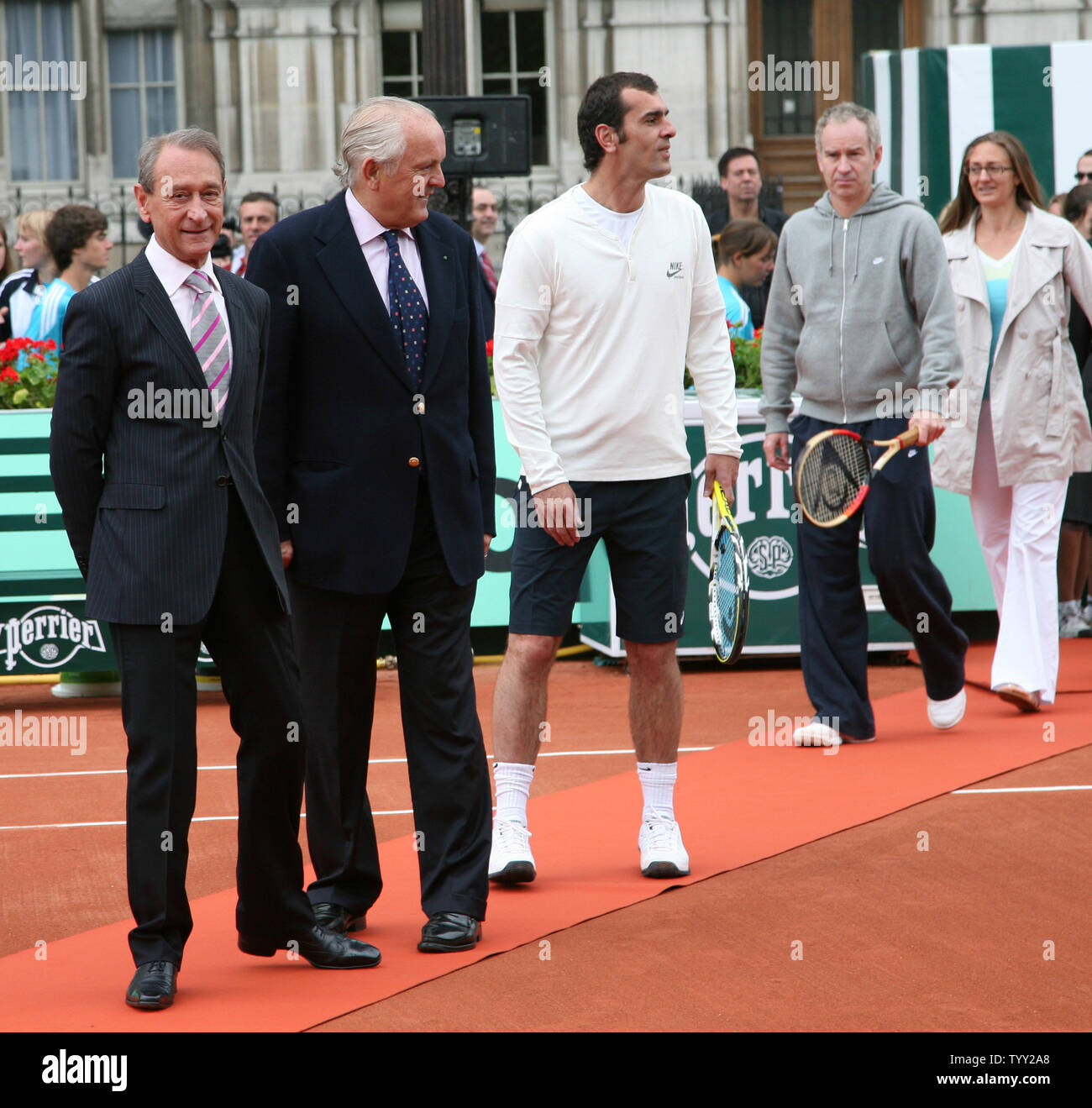 (From L to R) Mayor of Paris Bertrand Delanoe, President of the French Tennis Federation Christian Bimes, tennis greats Cedric Pioline, John McEnroe and Mary Pierce arrive on a clay court set up in front of the Hotel de Ville (city hall) during the launch of the exhibition 'Roland Garros in the City' in Paris on June 4, 2008.  The event coincides with the French Open tennis tournament taking place this week in Paris.   (UPI Photo/ David Silpa) Stock Photo