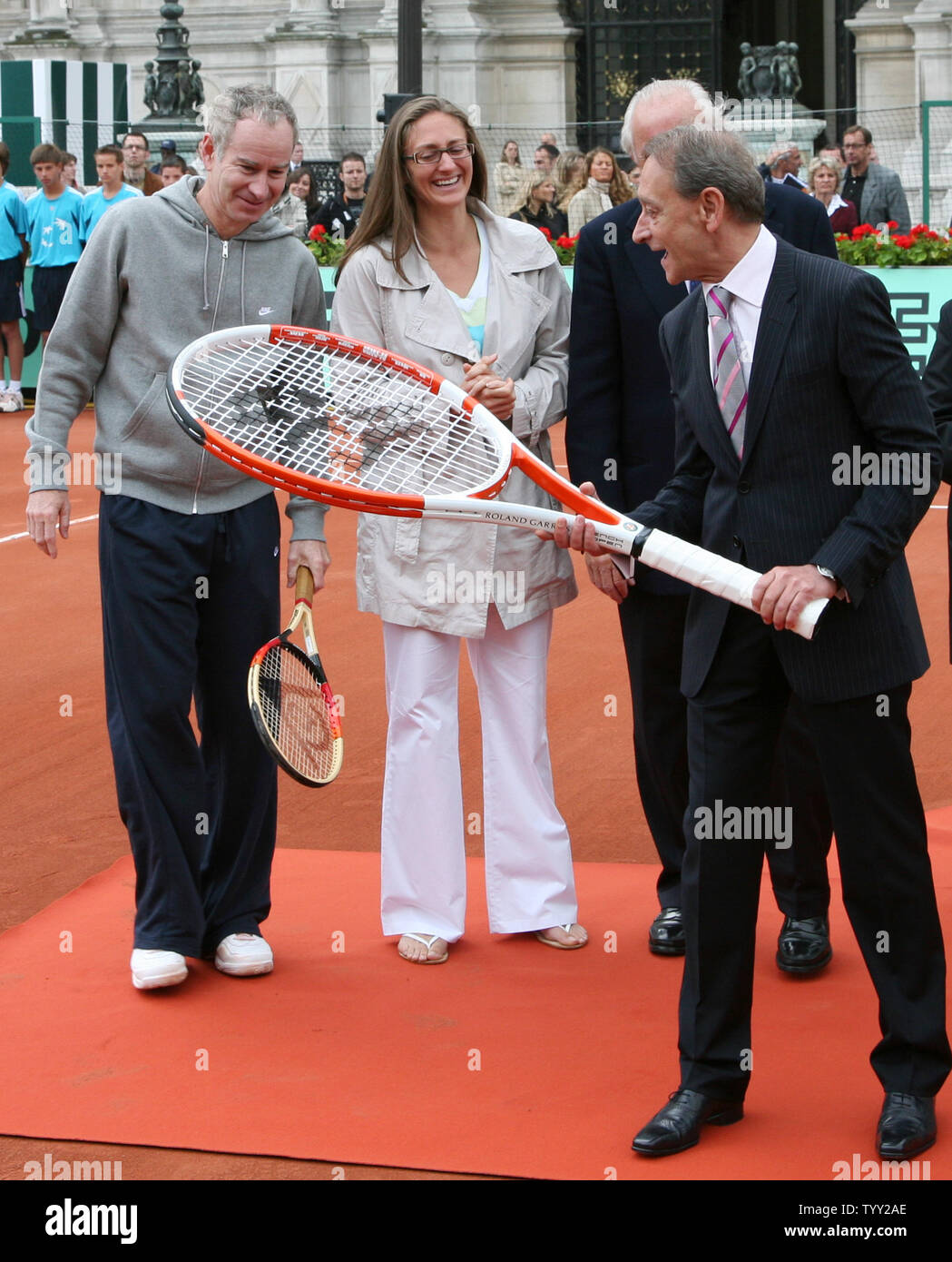 (From L to R) Tennis greats John McEnroe and Mary Pierce, President of the French Tennis Federation Christian Bimes (behind) and Mayor of Paris Bertrand Delanoe arrive on a clay court set up in front of the Hotel de Ville (city hall) during the launch of the exhibition 'Roland Garros in the City' in Paris on June 4, 2008.  The event coincides with the French Open tennis tournament taking place this week in Paris.   (UPI Photo/ David Silpa) Stock Photo