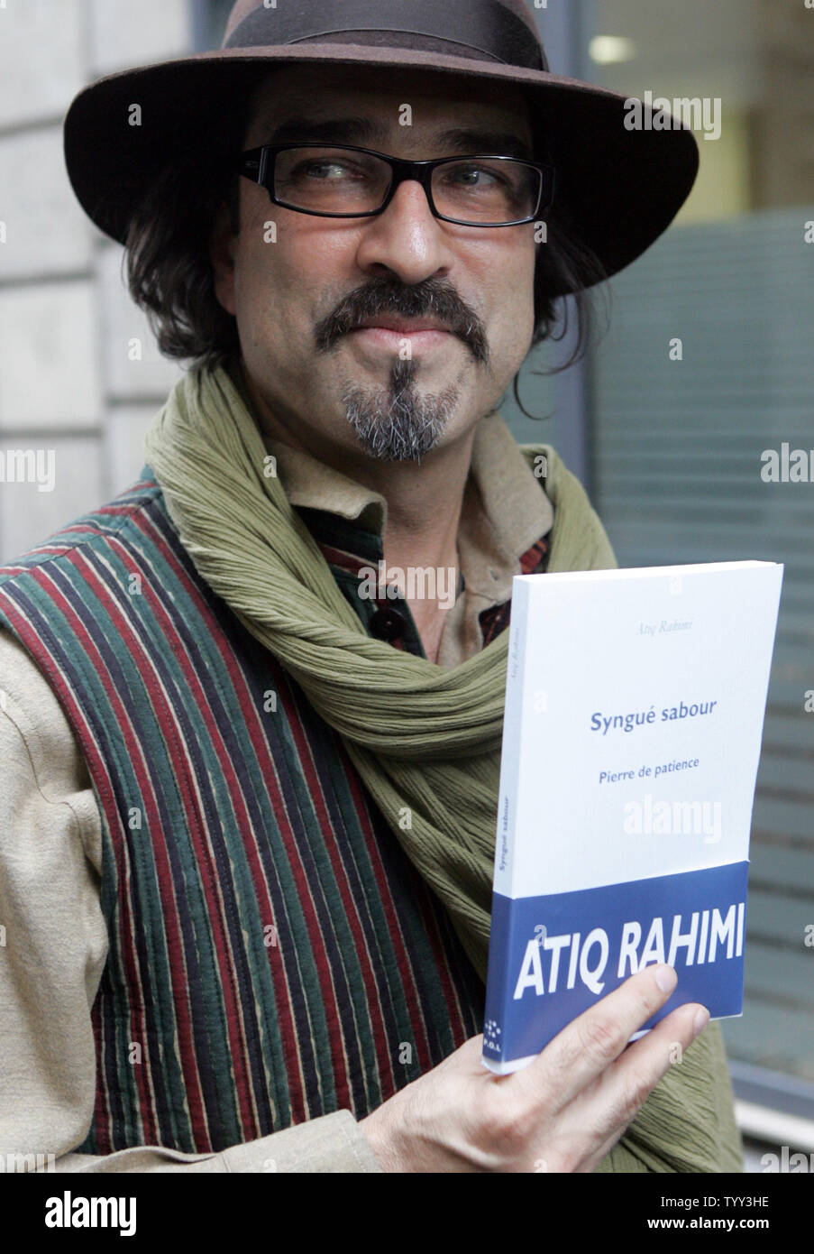 Afghan author Atiq Rahimi poses for photographers after he was awarded France's most prestigious literary prize, the 105-year-old Prix Goncourt, in Paris, November 10, 2008. The author who seeked asylum in France after the Soviet-invasion, wrote "Syngue Sabour'' or "Stone of Patience,'' the story of a woman in a country resembling Afghanistan whose husband has been wounded in battle and now lies as paralyzed as a stone. (UPI Photo/Eco Clement) Stock Photo