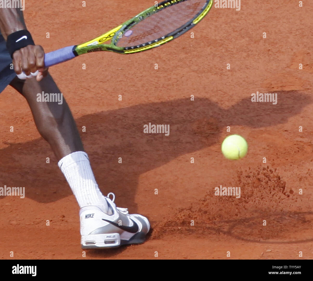 Clay is seen shooting from the foot of Frenchman Gael Monfils as he slides  during his French Open quarterfinal match against Roger Federer of  Switzerland at Roland Garros in Paris on June
