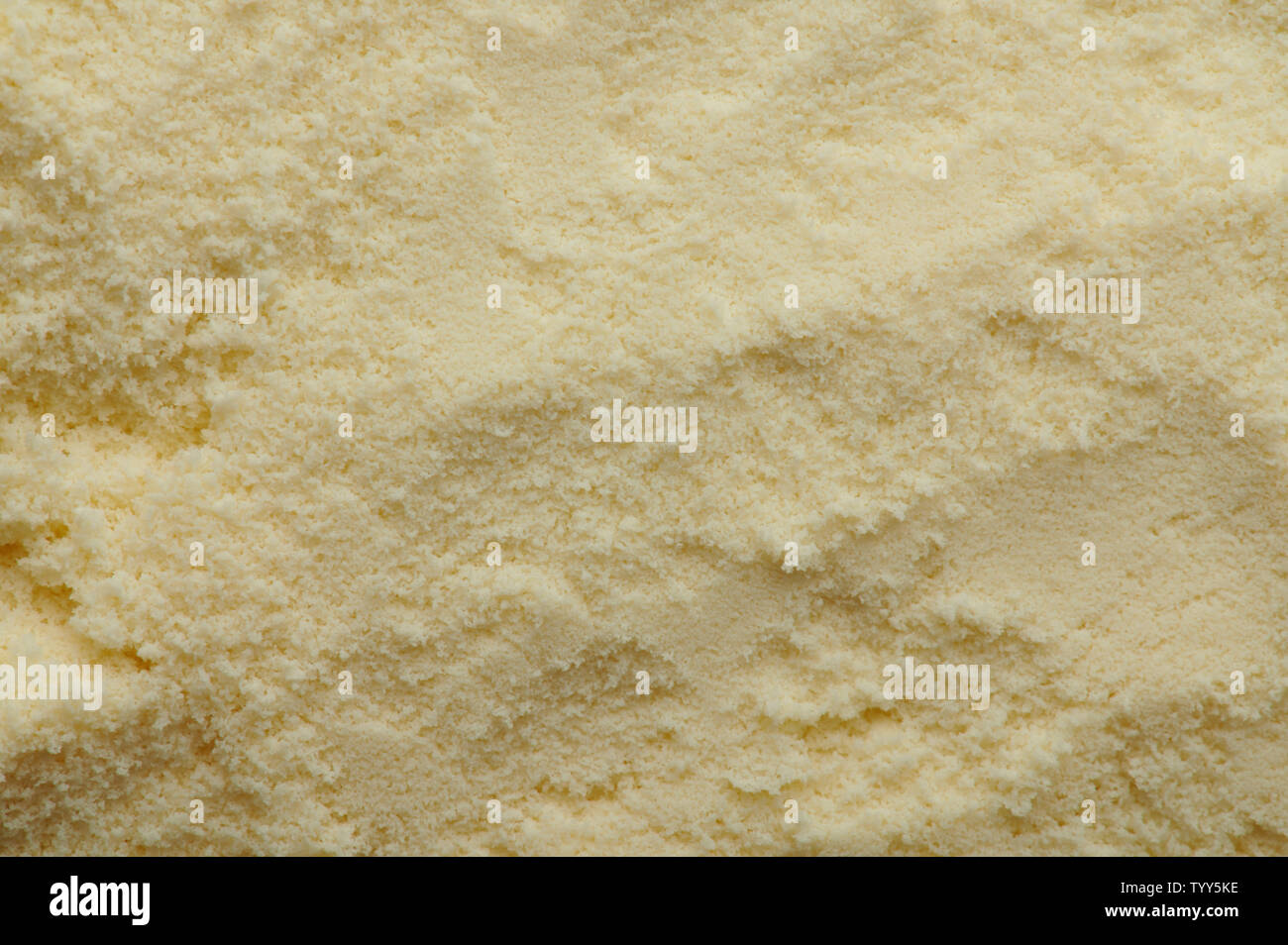 Yellow dry food powder macro close up texture view Stock Photo