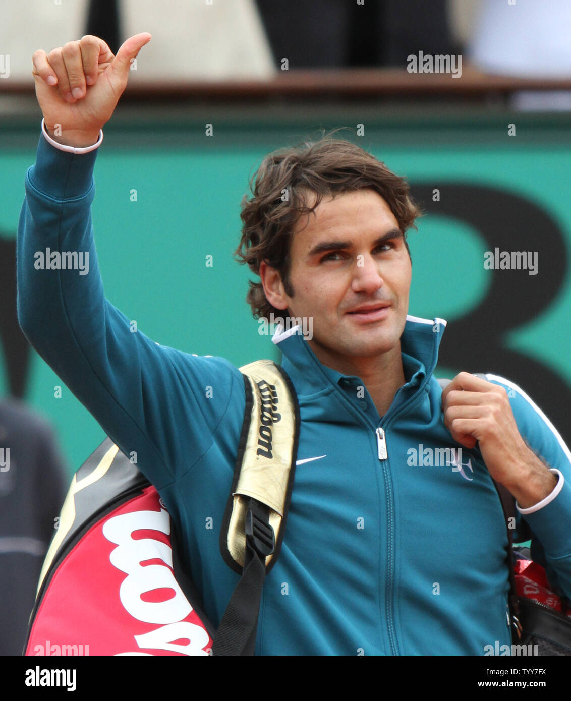Roger Federer of Switzerland acknowledges the crowd after winning his French Open fourth-round against Stanislas Wawrinka of Switzerland at Roland Garros in Paris on May 30, 2010. Federer defeated Wawrinka 6-3,