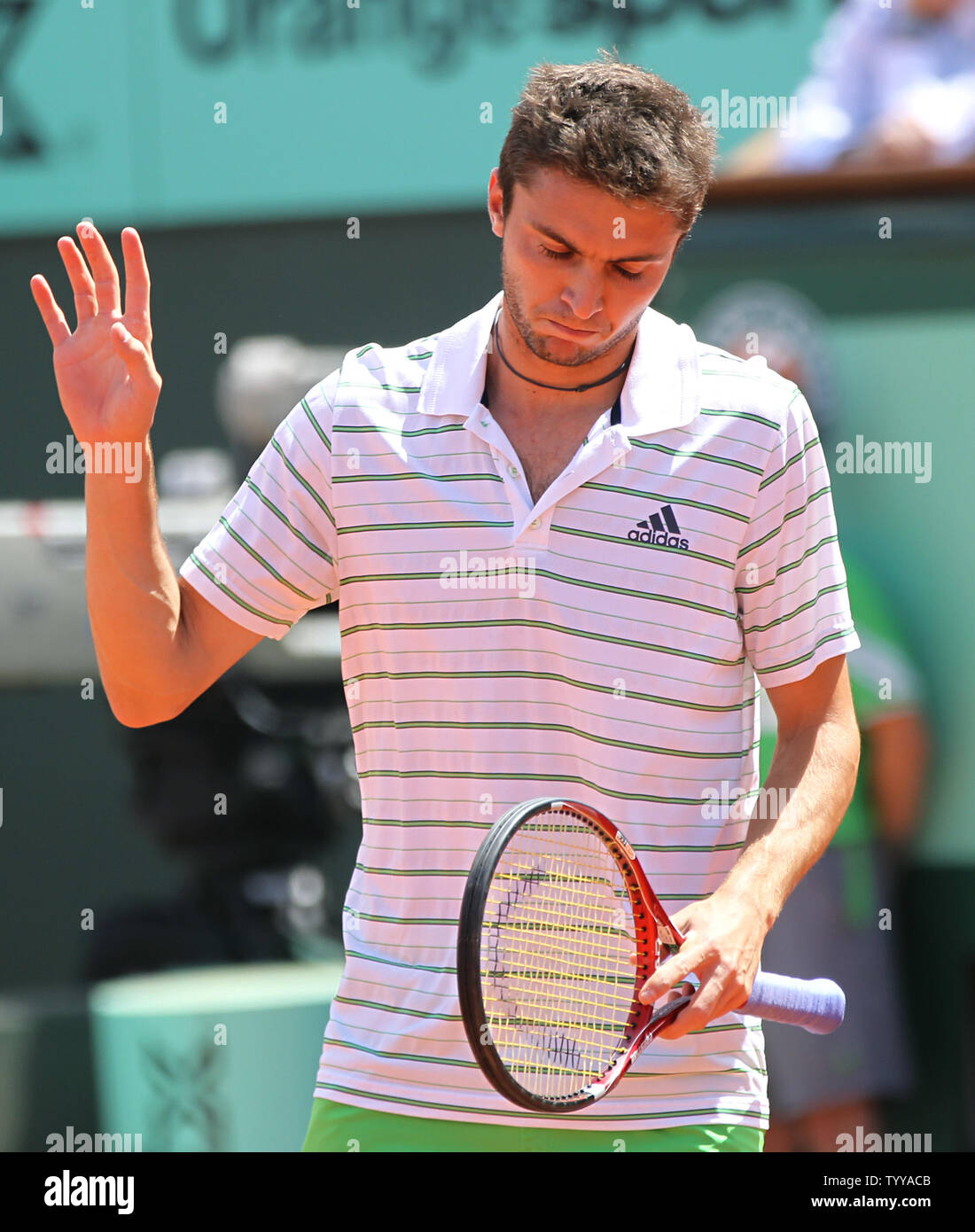 Gilles Simon of France apologizes after winning a point on a net ...