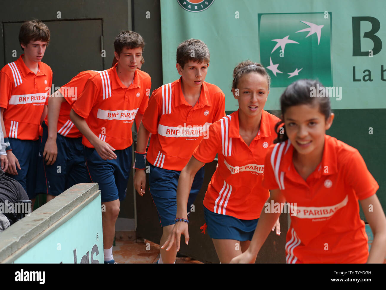 Ball Boys And Girls Enter The Court During The French Open Mens Second Round Match Between Spaniard Nicolas Almagro And Marcos Baghdatis Of Cyprus At Roland Garros In Paris On May 31