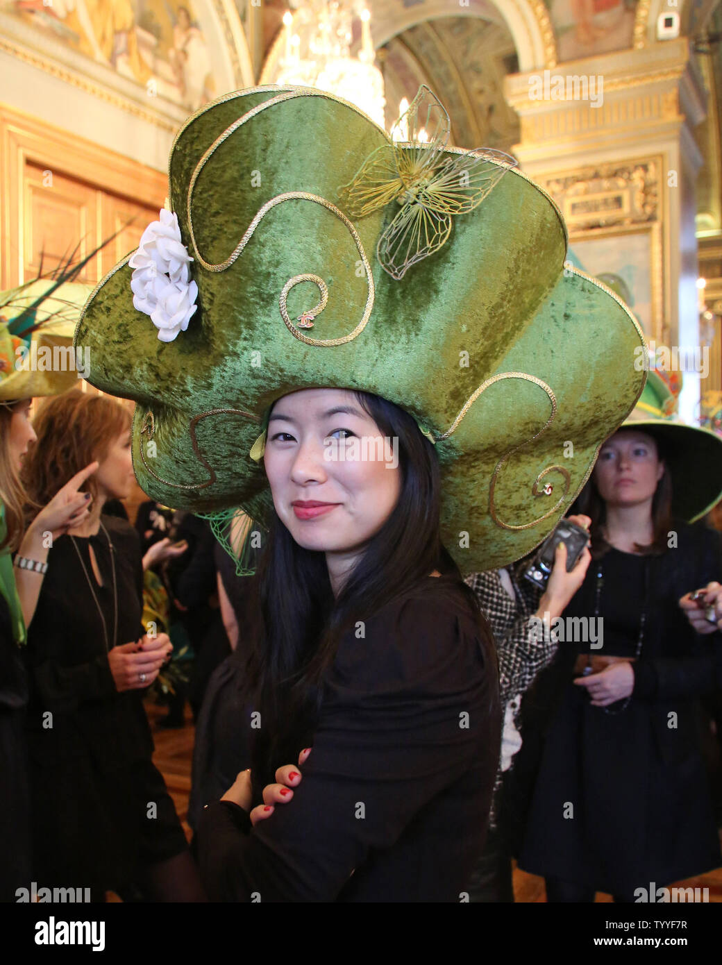 A student model representing a French fashion house sports a designer hat  during the annual Sainte Catherine Day fashion show at city hall in Paris  on November 23, 2012. The models, known