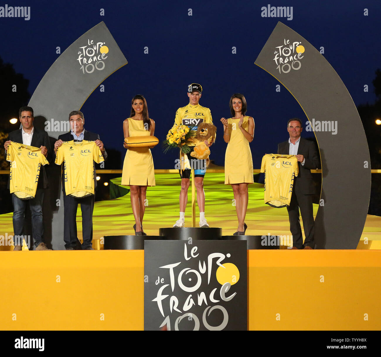 (From L to R) Miguel Indurain of Spain, Eddie Merckx of Belgium, Chris Froome of Great Britain and Bernard Hinault of France arrive on the presentation podium after Froome won the Tour de France in Paris on July 21, 2013.  Froome became Britain's second consecutive Tour winner after Bradley Wiggins won the event last year.   UPI/David Silpa Stock Photo