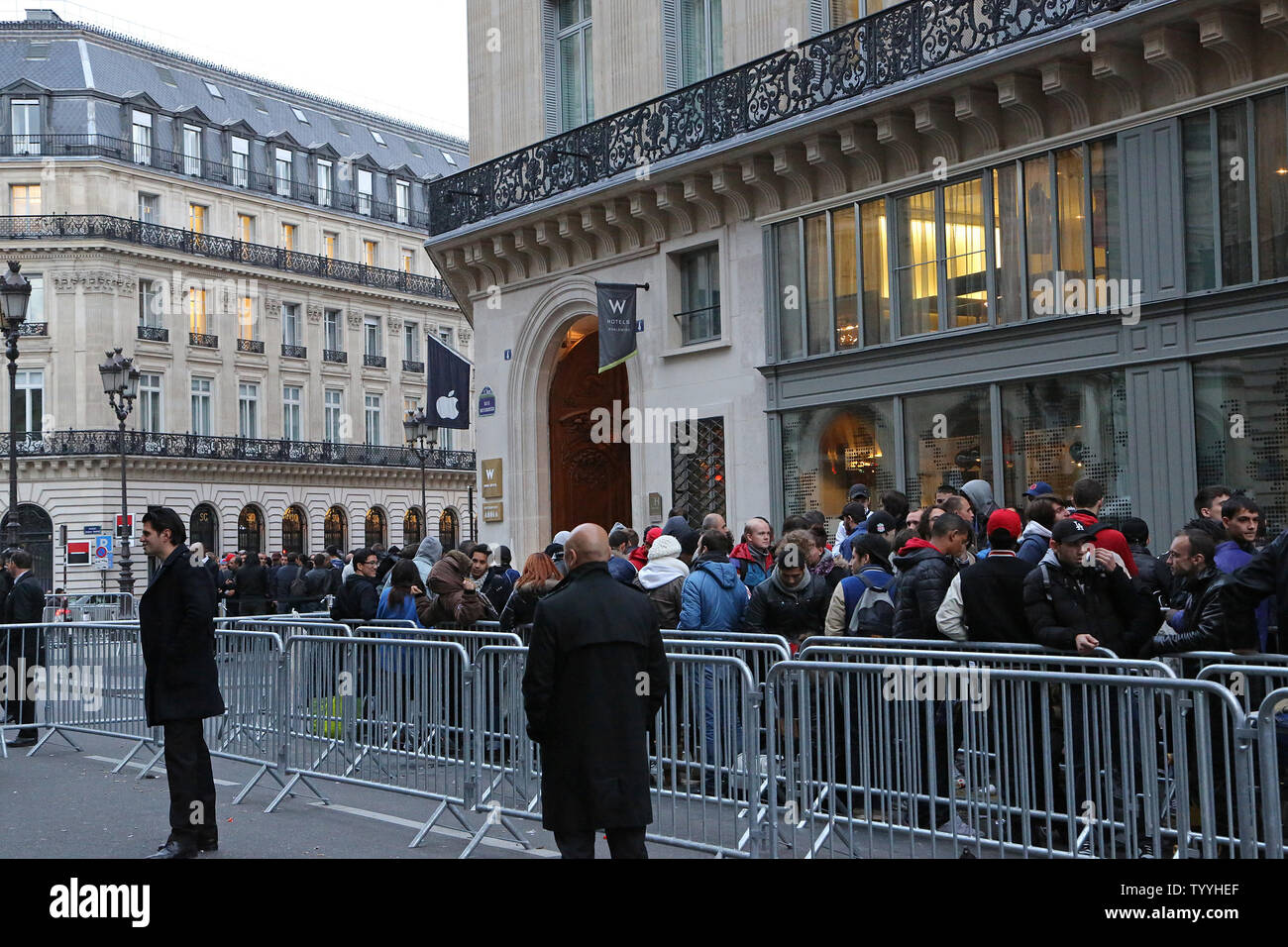 Customers line up in front of the Apple Store near Place de l'Opera before the launch of the new iPhone5s and iPhone5c today in Paris on September 20, 2013.  The iPhone 5s features a new Touch ID fingerprint sensor on the home button that allows users to unlock their phone without using a password while the iPhone 5c offers users a choice of various colors.   UPI/David Silpa Stock Photo