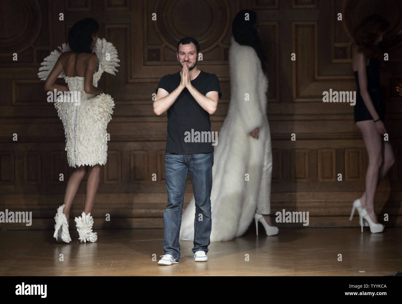 Turkish-born Belgian  fashion designer Serkan Cura salutes the audience at the end of the presentation of his Fall-Winter 2014-2015 High Fashion collection in Paris, France on July 10, 2014   UPI/Maya Vidon-White Stock Photo
