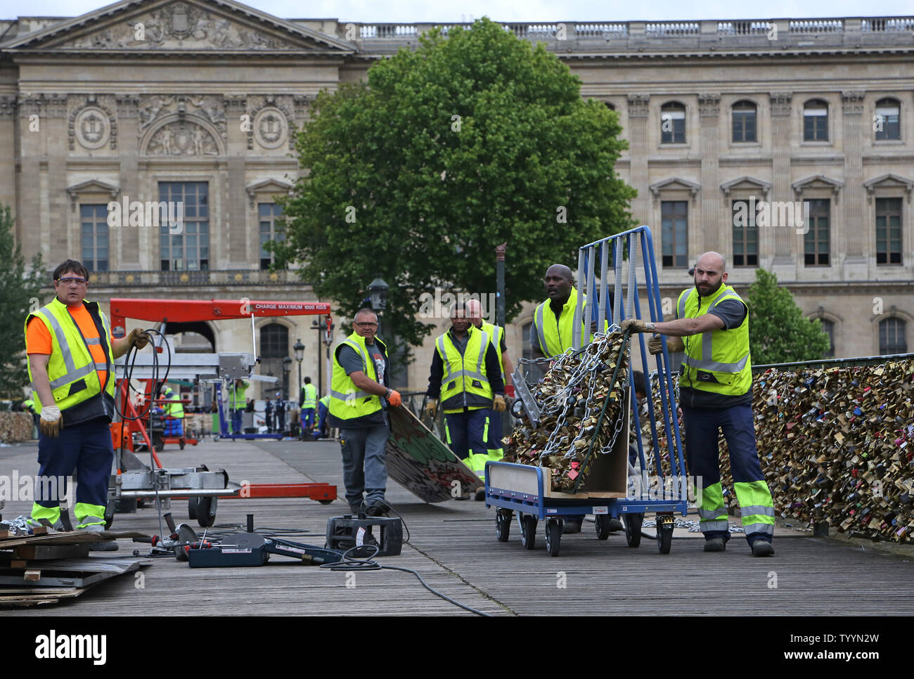 Workers remove locks from the Pont des Arts bridge in Paris on June 1, 2015.  After an extended debate, French officials began removing the locks, attached by tourists as a symbol of love, due to the risk the weight of the locks poses to the structural integrity of the bridge.   Photo by David Silpa/UPI Stock Photo
