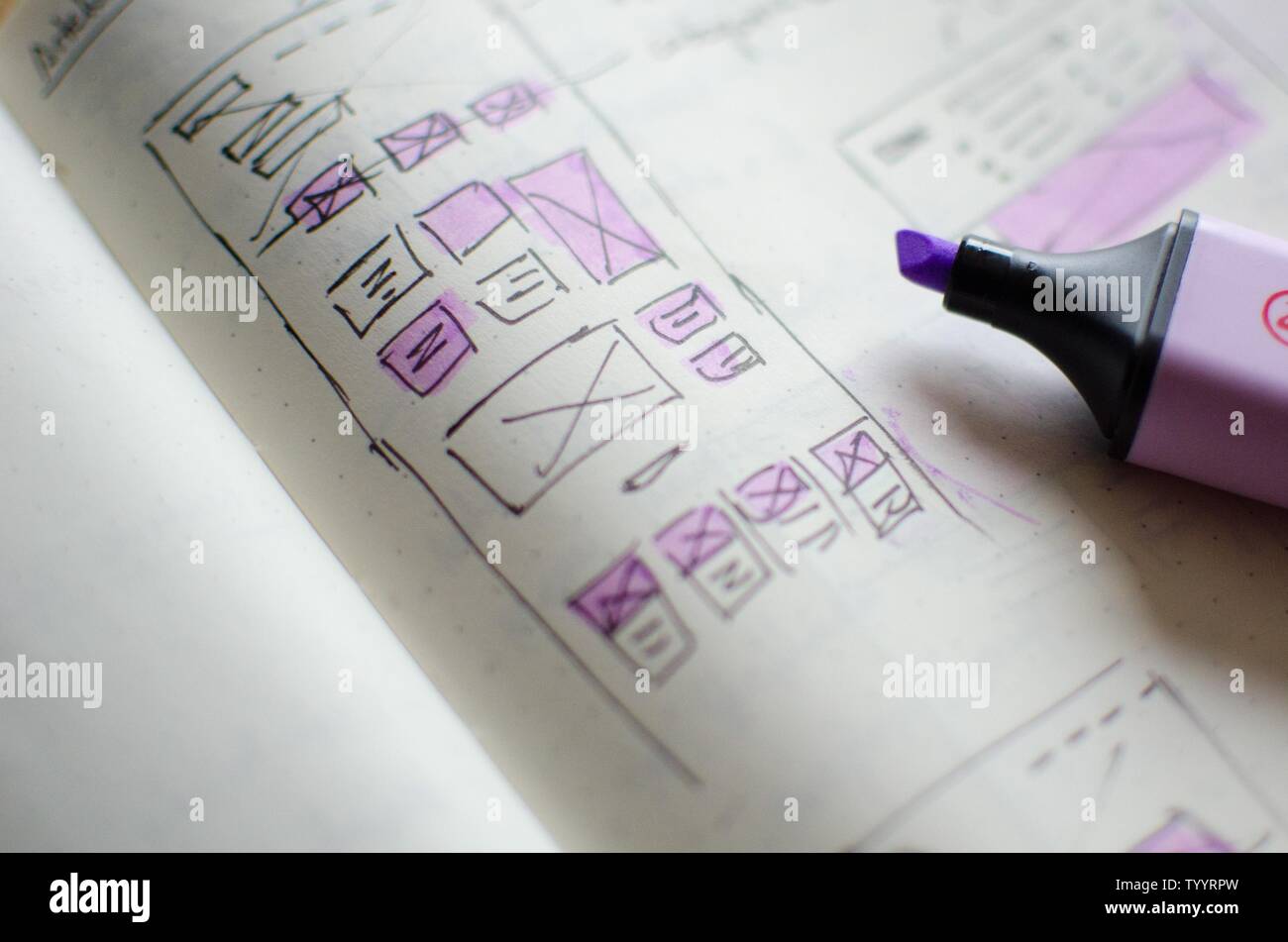 Closeup of UI/UX draft sheet with highlighted areas with a magic marker ...