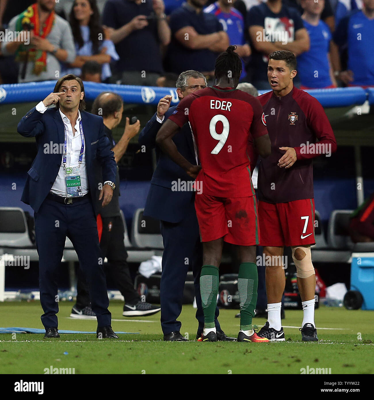 Cristiano Ronaldo of Portugal and coach Fernando Santos pass on instructions to Eder during the Euro 2016 Final match at the Stade de France in Paris, France on July 10, 2016. Portugal beat France 1-0 after extra-time to secure their first European Championship. Photo by Chris Brunskill/UPI Stock Photo